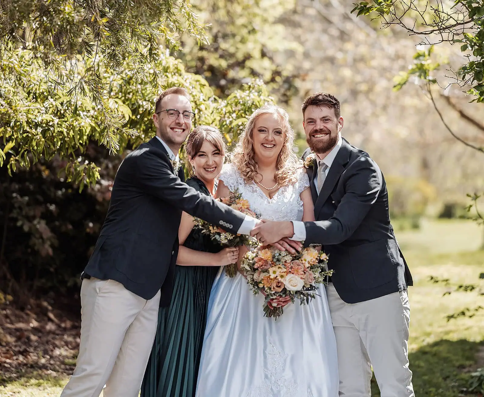 grand cru estate wedding - isabella & nick 115 Bride and groom celebrate joyfully with friends at an outdoor wedding.