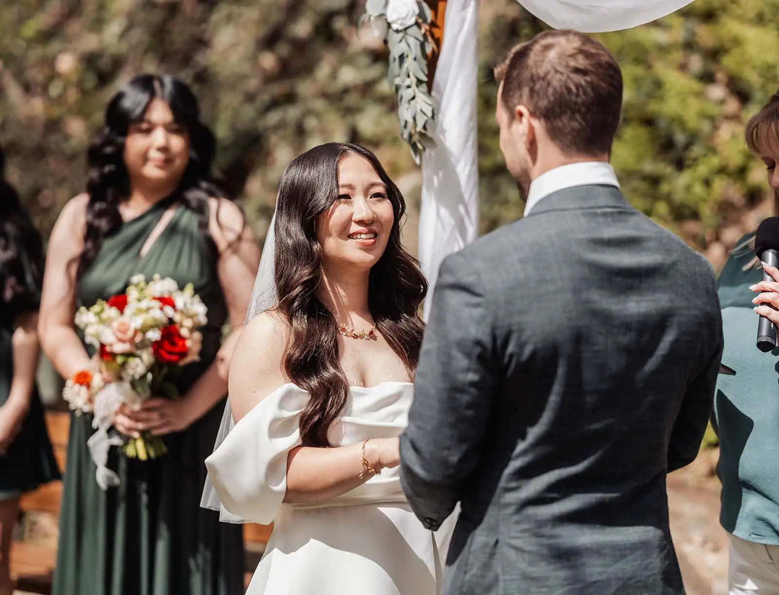utopia waterfall gully wedding - sally & ben 222 Elegant wedding ceremony archway adorned with flowers and greenery.