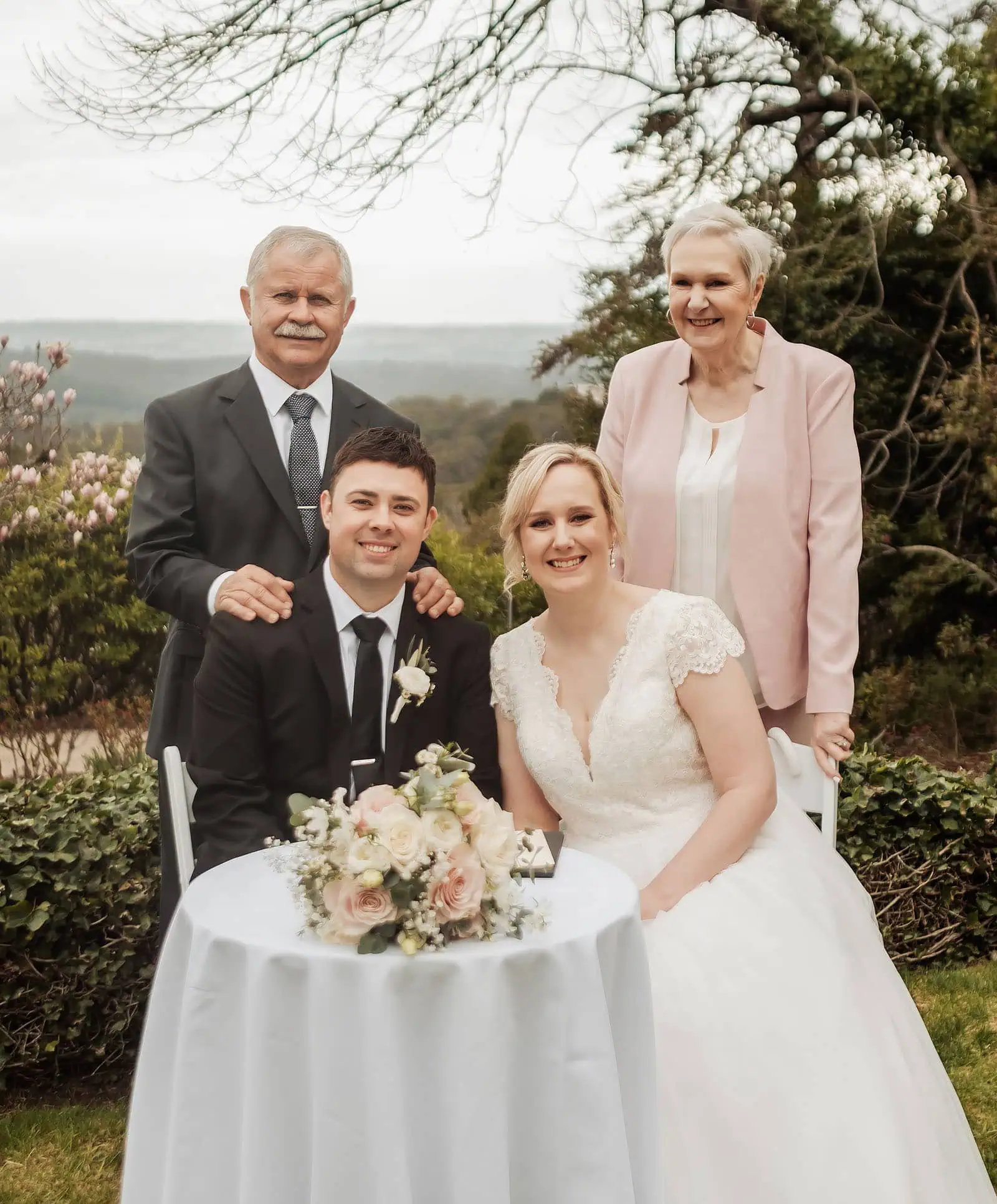 mt lofty house elopement - kimberley & michael 186 Family gathered at wedding ceremony smiling.
