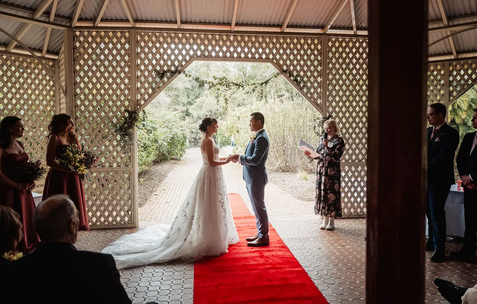 adelaide botanic gardens summerhouse wedding - belinda & ian 168 Elegant gazebo for outdoor wedding ceremony, decorated with flowers and drapes.