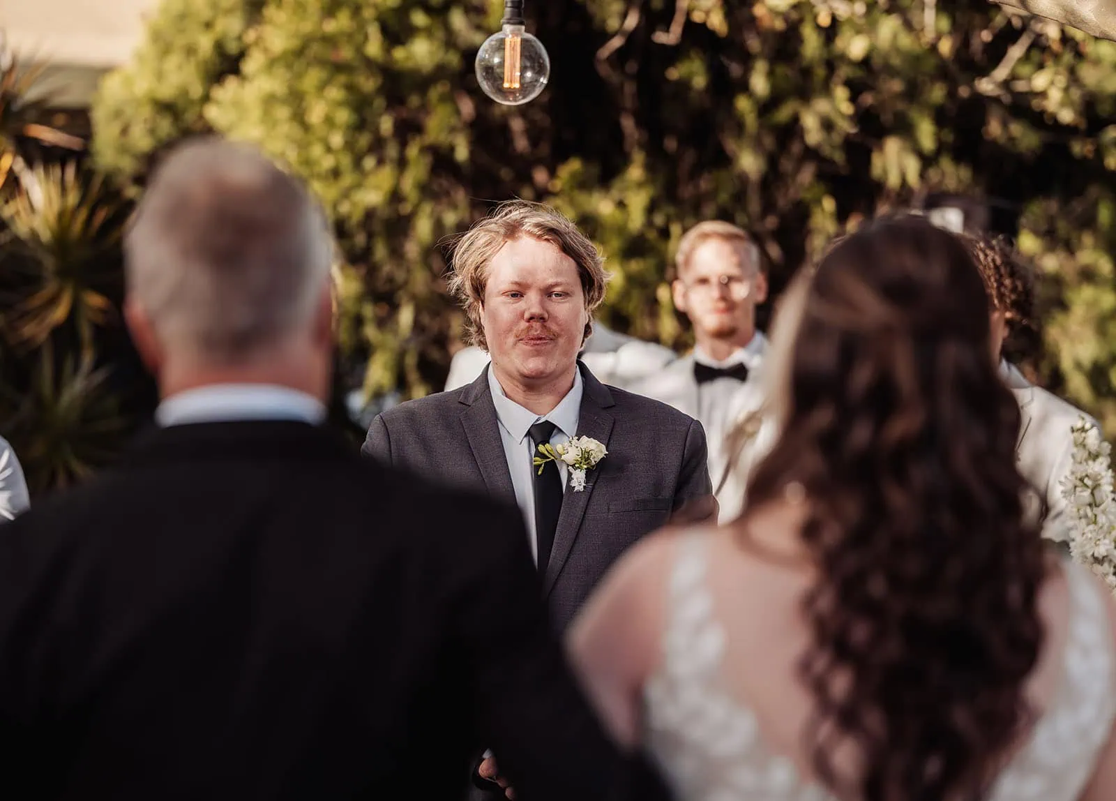 beach rd wines wedding - hana & jessie 56 Bride and groom exchange vows during romantic outdoor wedding ceremony.