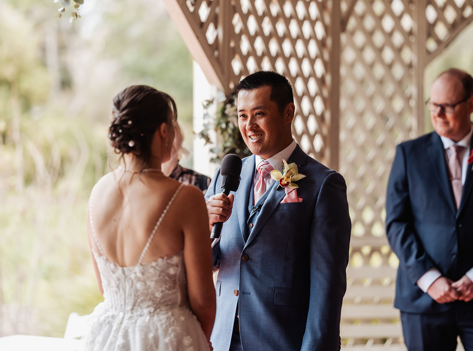 adelaide botanic gardens summerhouse wedding - belinda & ian 166 Bride and groom exchanging vows at outdoor wedding ceremony.