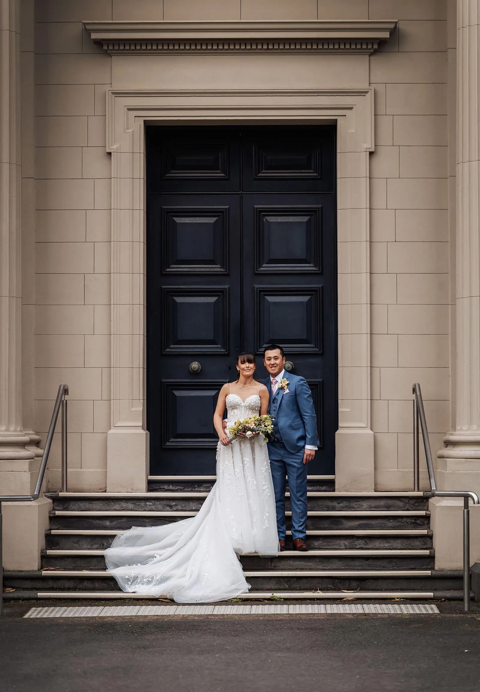 adelaide botanic gardens summerhouse wedding - belinda & ian 192 Wedding couple pose elegantly before grand historic doors.