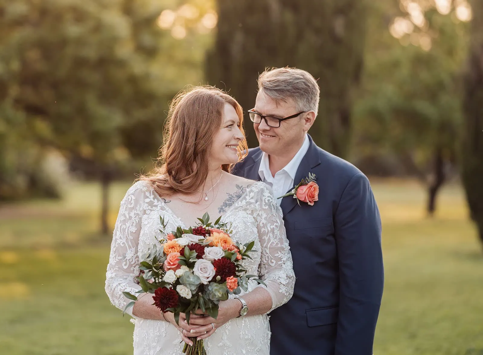 carrick hill wedding - jo & david 311 Bride and groom embrace in a lush garden setting.
