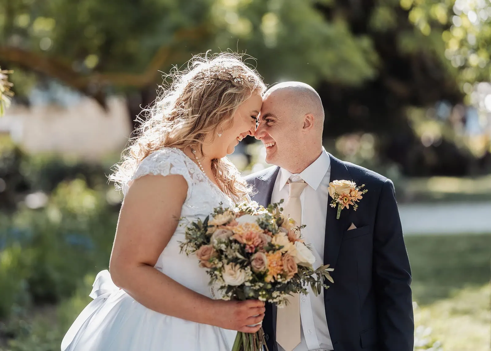 grand cru estate wedding - isabella & nick 130 Bride and groom embrace in a lush garden setting.