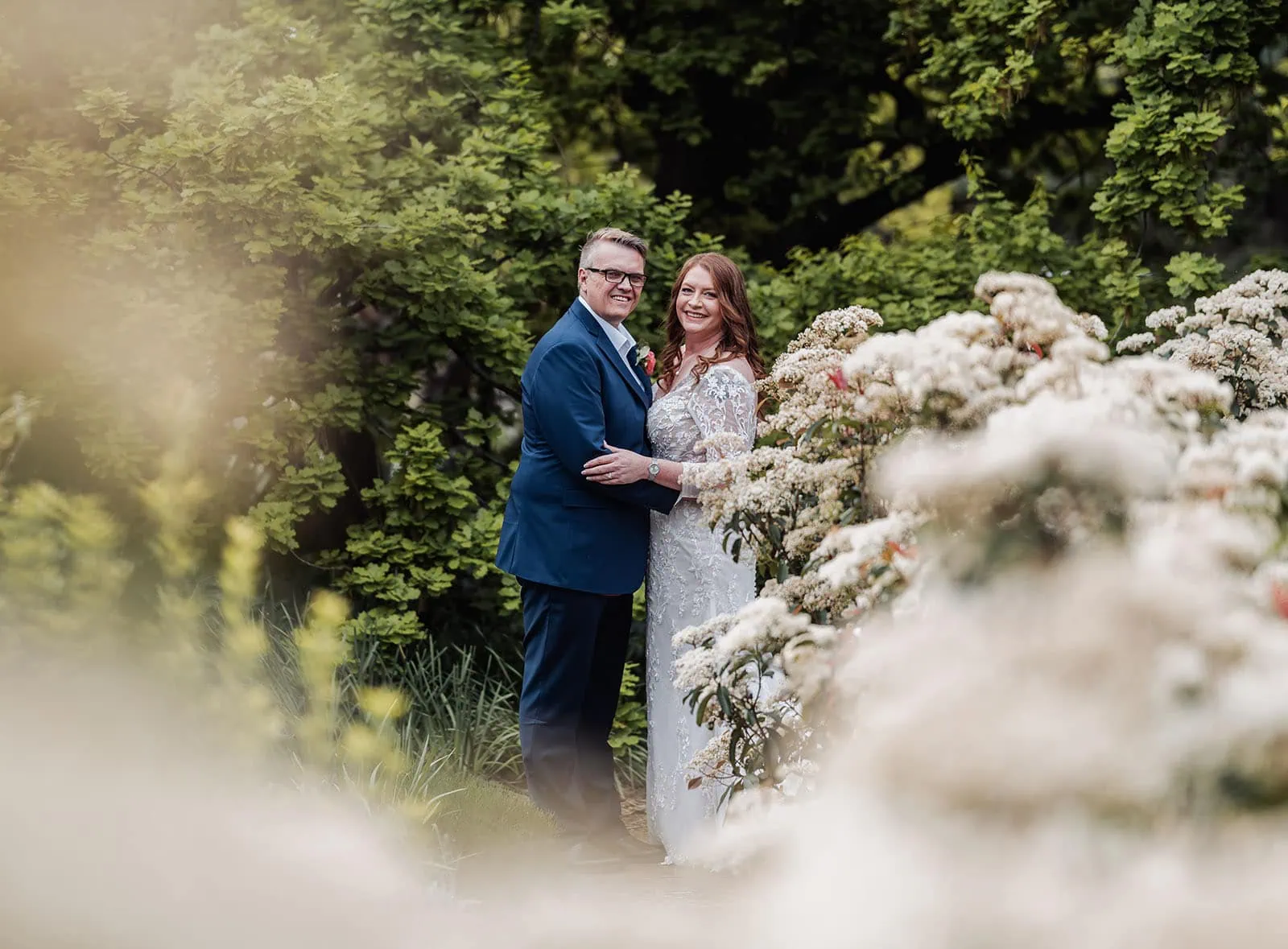 carrick hill wedding - jo & david 282 Bride and groom embracing in a beautiful garden setting.