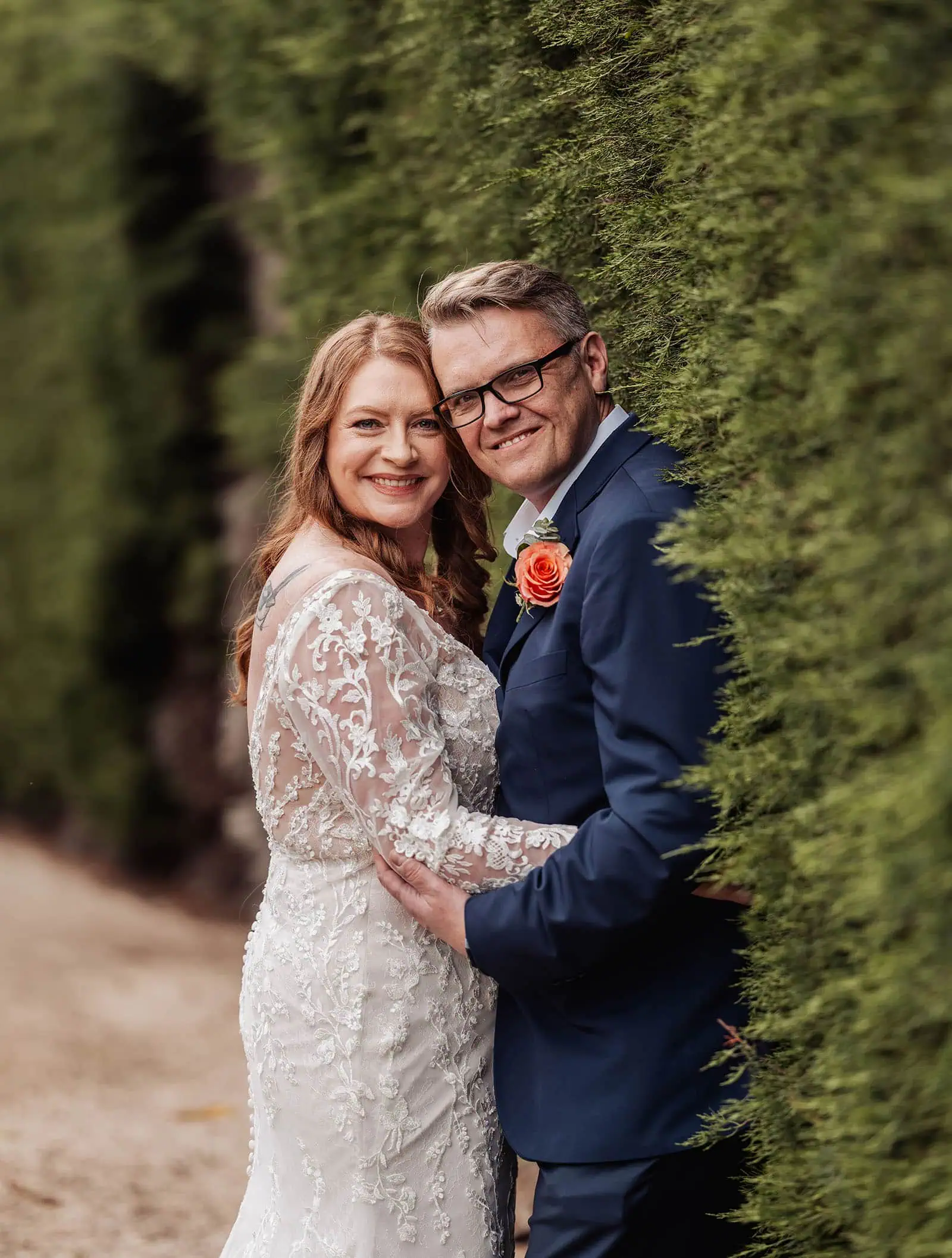 carrick hill wedding - jo & david 279 Bride and groom posed elegantly against lush green backdrop.