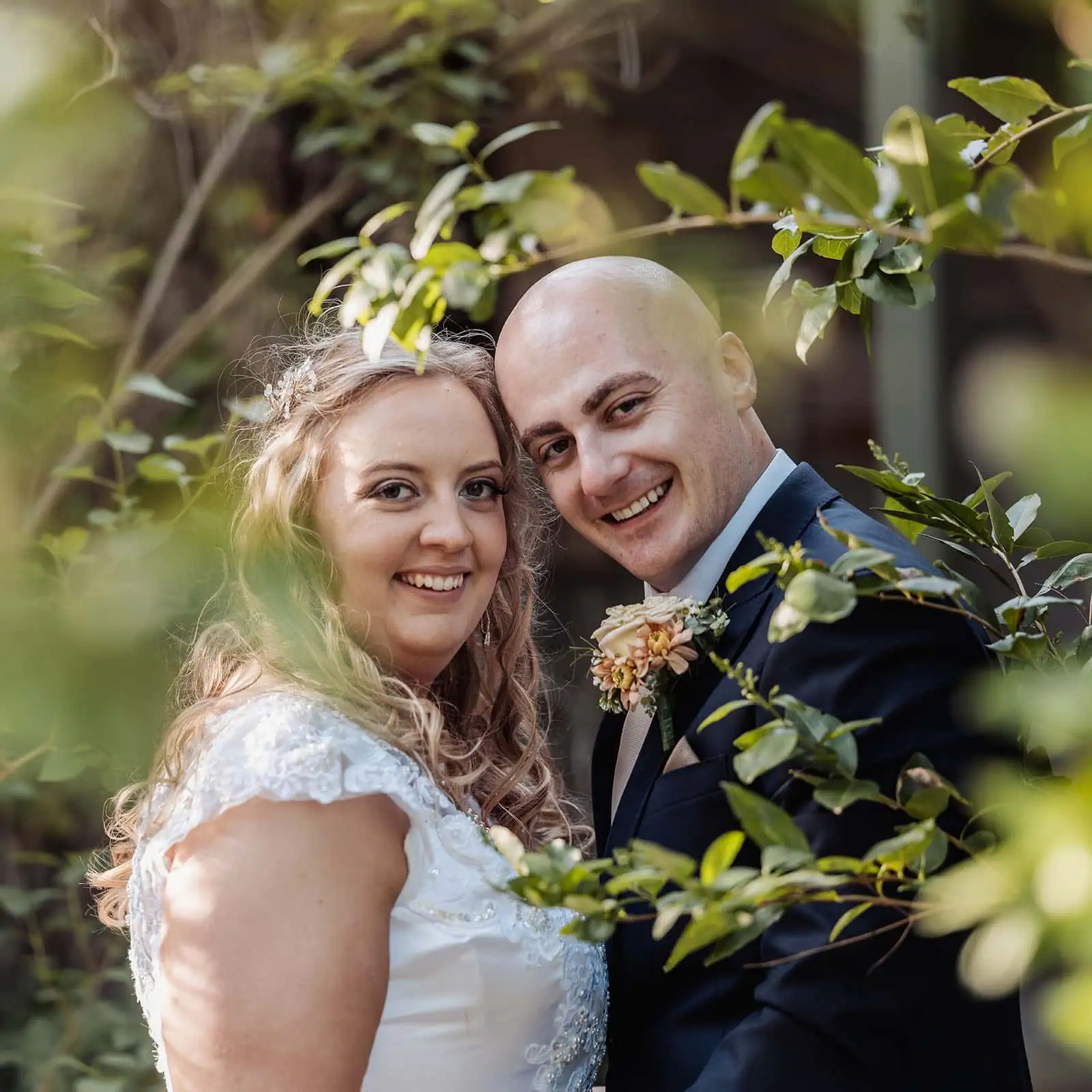 grand cru estate wedding - isabella & nick 146 Bride and groom surrounded by lush greenery on their wedding day.