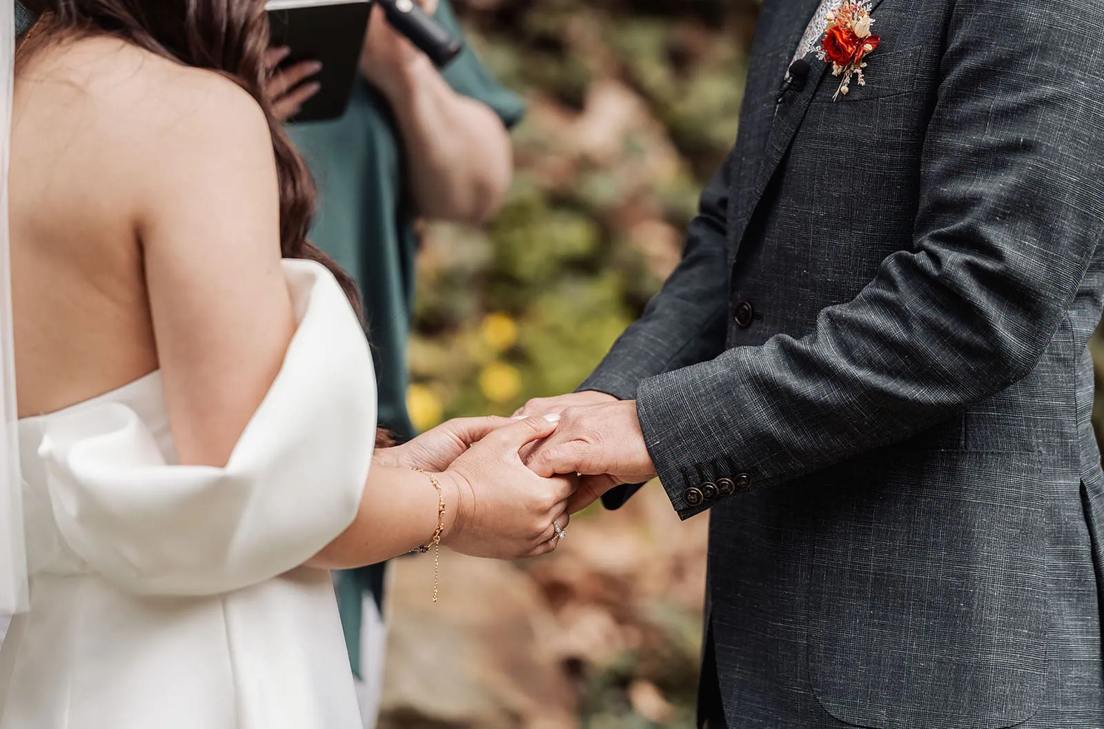 utopia waterfall gully wedding - sally & ben 226 Bride and groom holding hands during wedding ceremony.