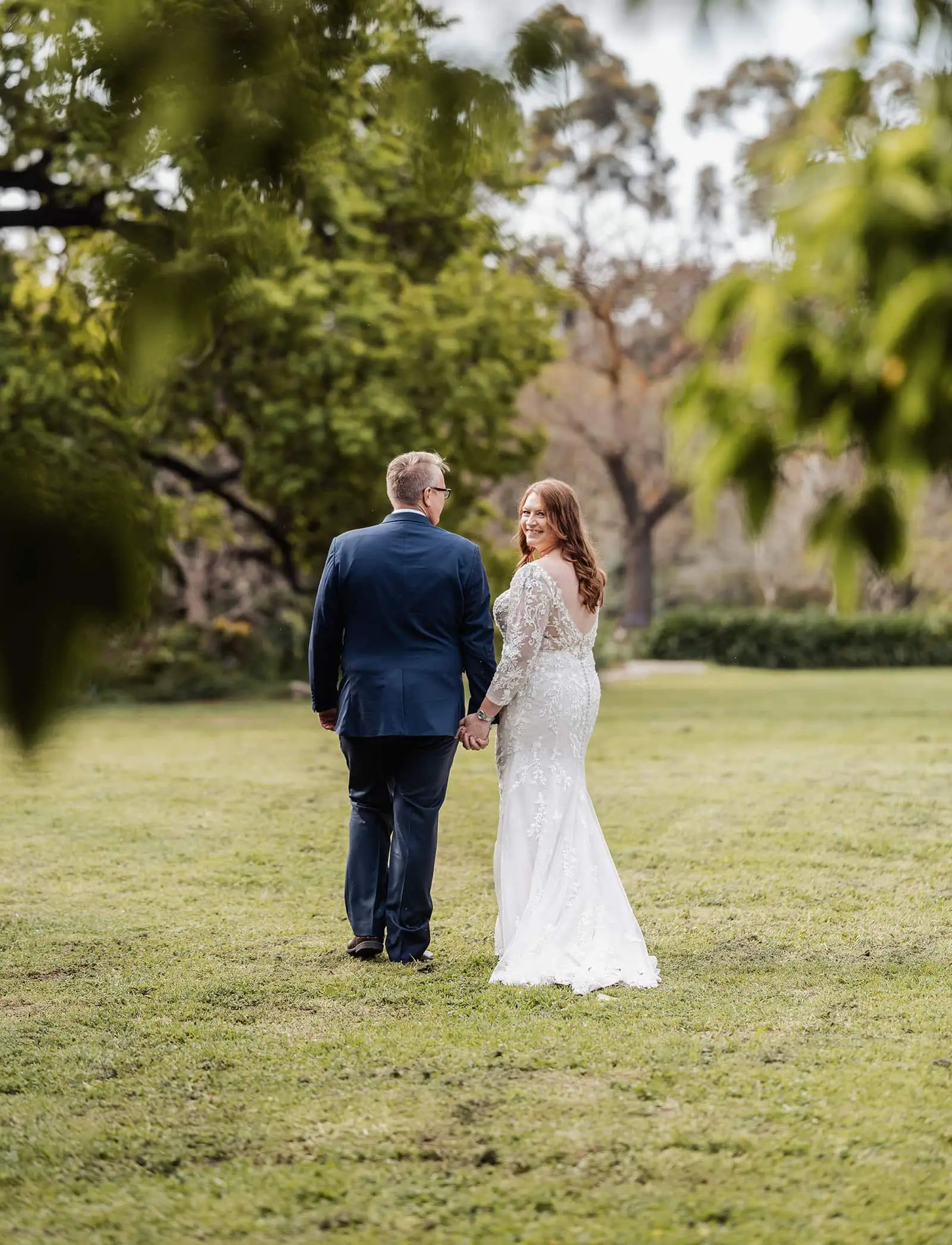 carrick hill wedding - jo & david 281 Bride and groom embrace in scenic outdoor wedding setting.