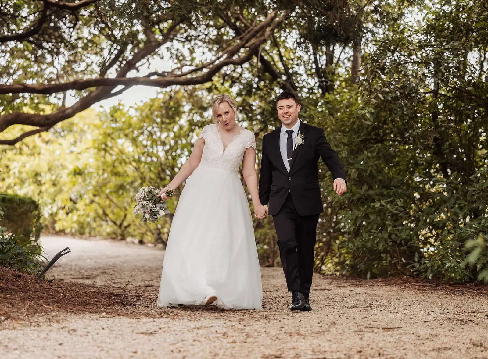 mt lofty house elopement - kimberley & michael 205 Bride and groom walking on scenic path surrounded by nature, wedding romance.