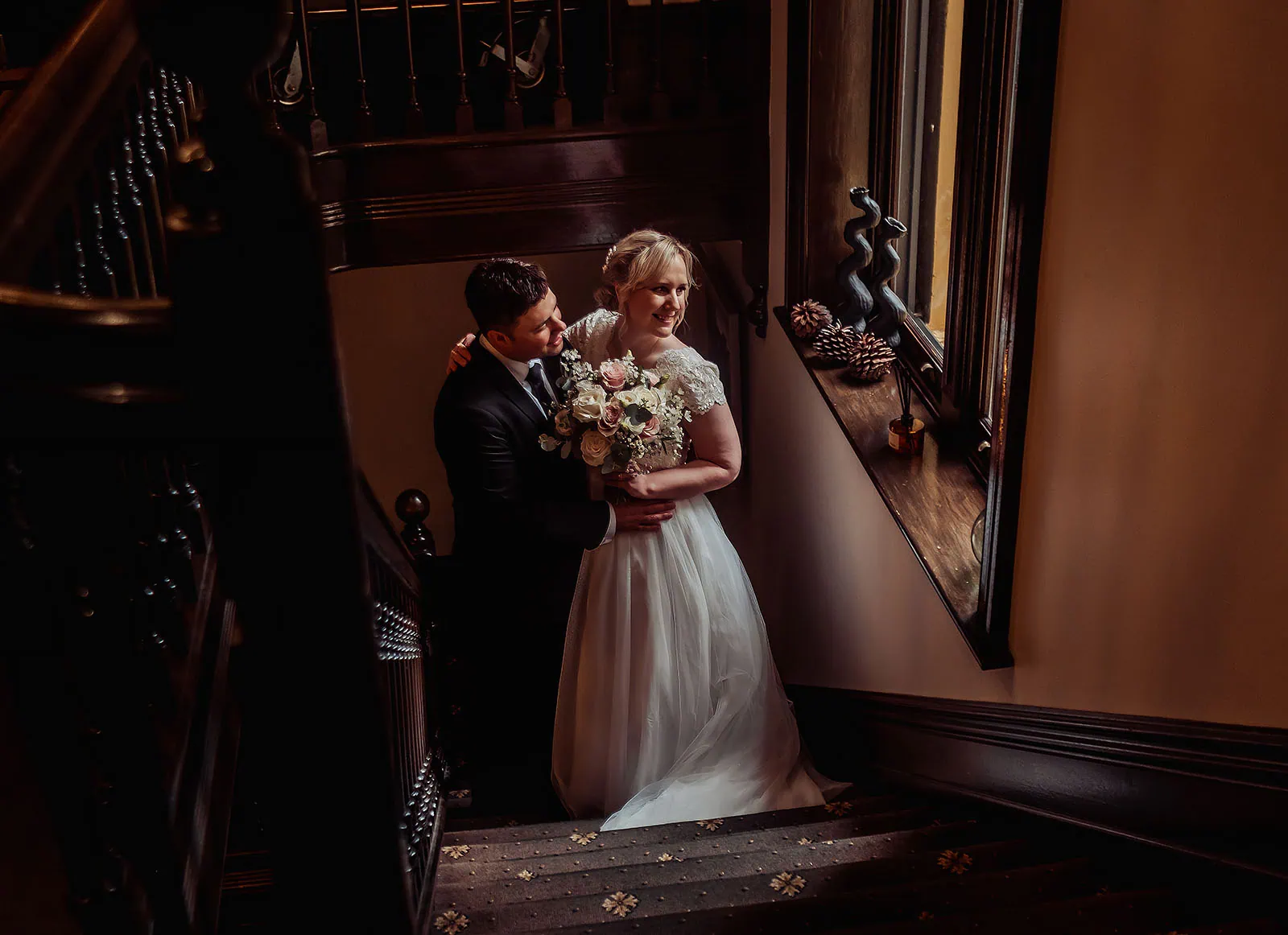 mt lofty house elopement - kimberley & michael 190 Bride and groom on elegant staircase at wedding ceremony.