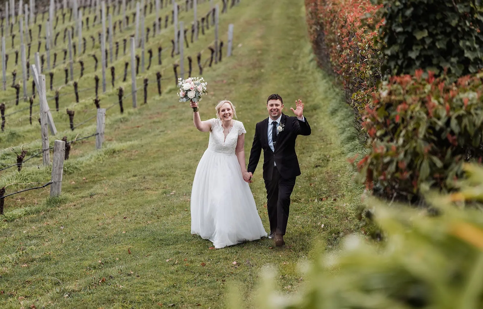 mt lofty house elopement - kimberley & michael 211 Wedding couple embracing in vineyard at sunset.