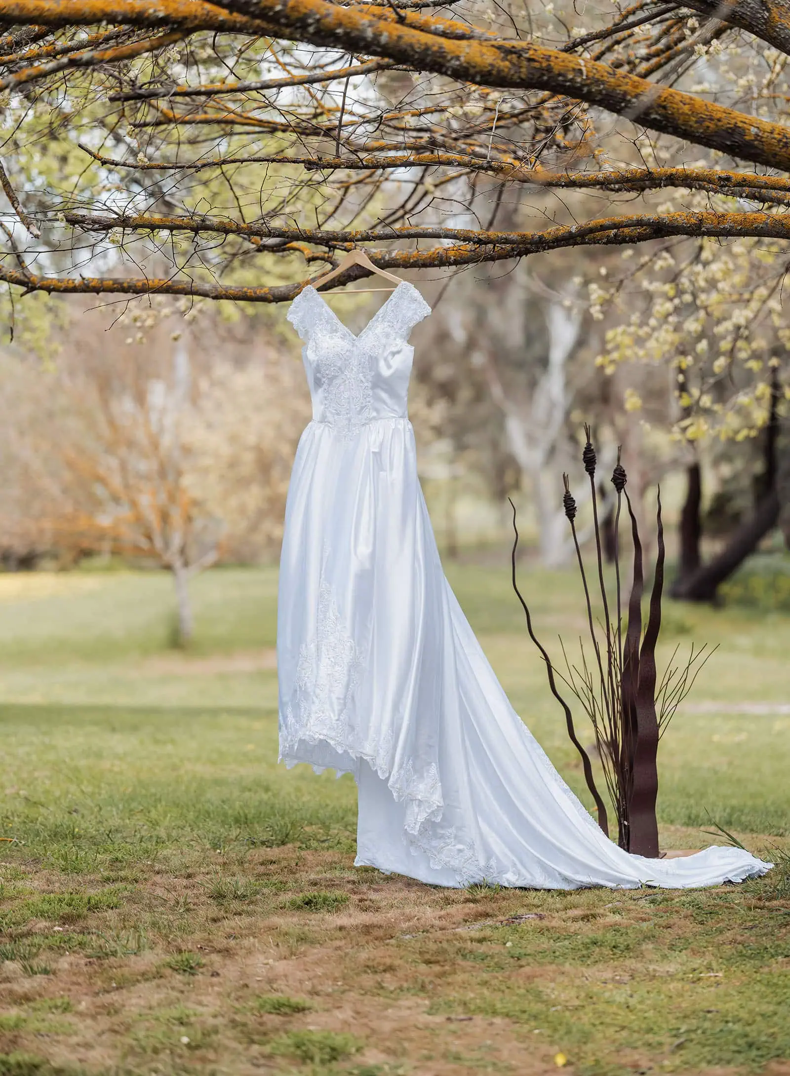 grand cru estate wedding - isabella & nick 105 Bride in elegant wedding dress surrounded by vibrant garden blooms.