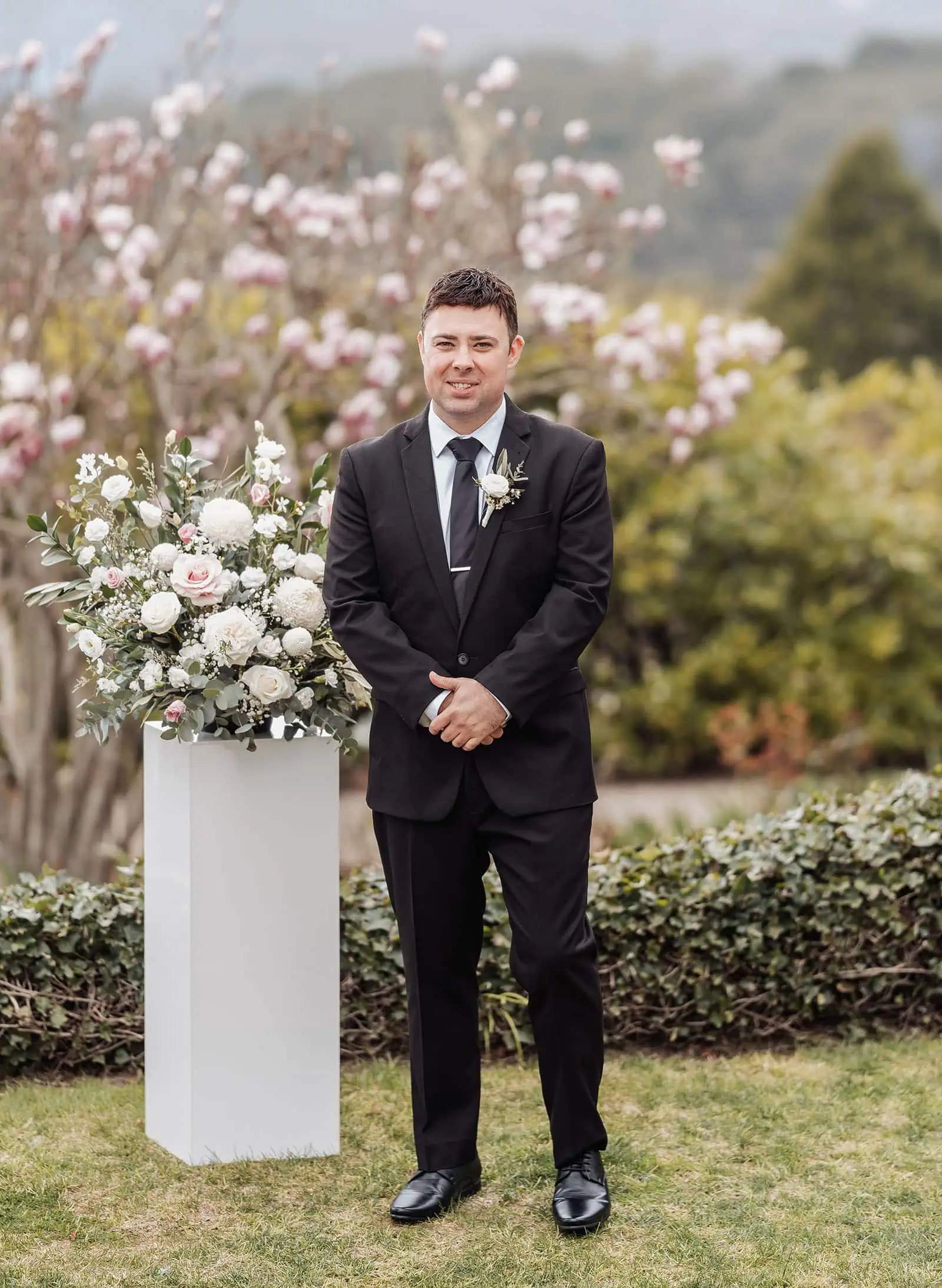 mt lofty house elopement - kimberley & michael 177 Groom in spring floral setting with elegant wedding attire.