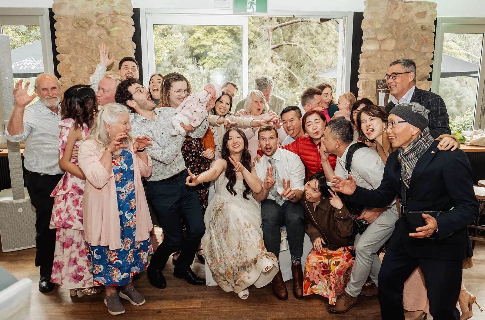 utopia waterfall gully wedding - sally & ben 262 Wedding party smiles together in joyful celebration.