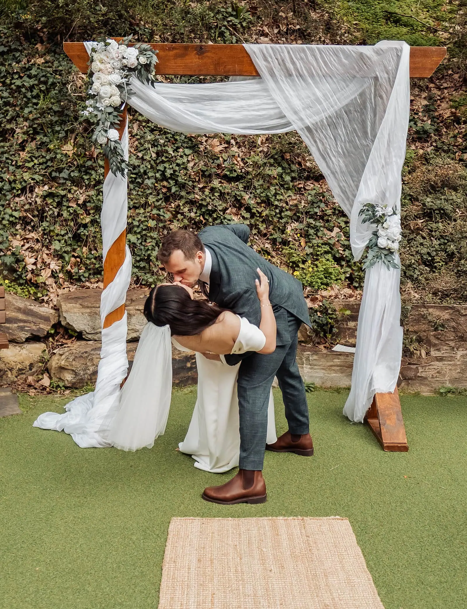 utopia waterfall gully wedding - sally & ben 228 Bride and groom share a romantic kiss at their wedding ceremony.