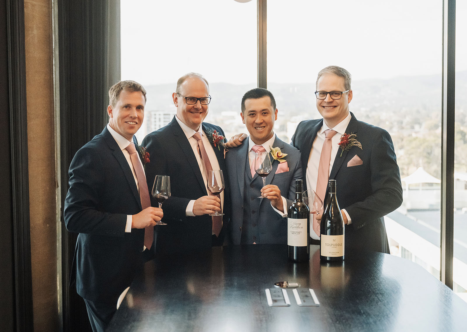adelaide botanic gardens summerhouse wedding - belinda & ian 132 Cheers at a joyful wedding celebration with toasting glasses raised high.