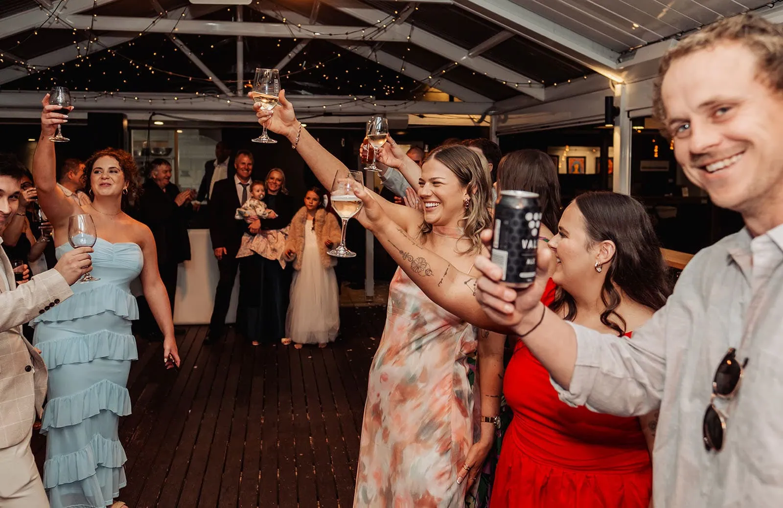 beach rd wines wedding - hana & jessie 91 Bride and groom raising glasses at wedding celebration.