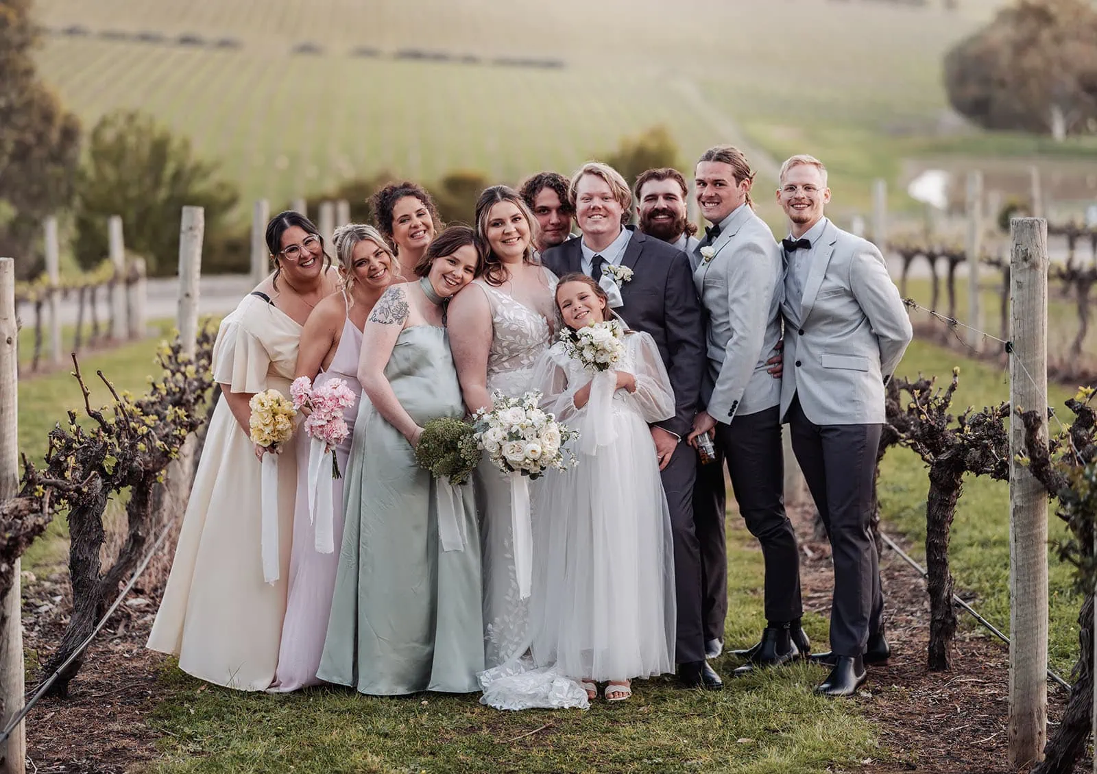 beach rd wines wedding - hana & jessie 80 Wedding celebration at a picturesque vineyard under a clear blue sky.
