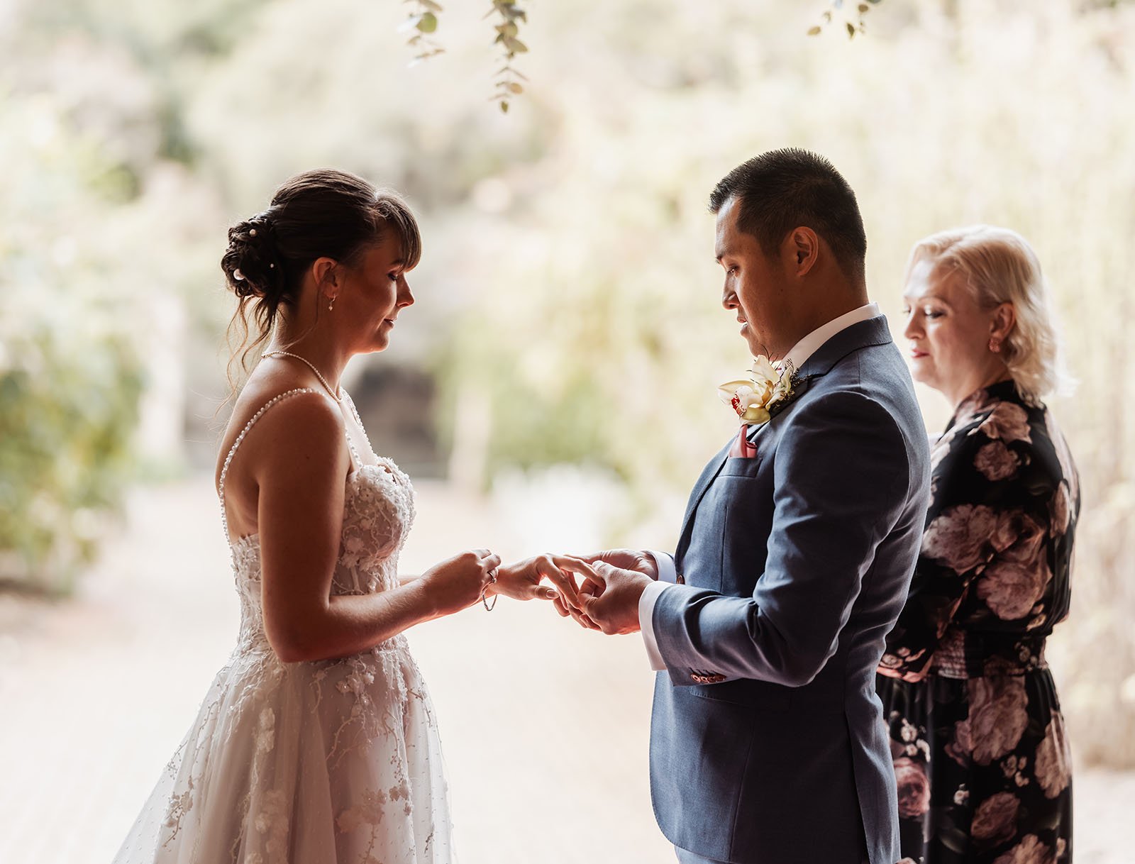 adelaide botanic gardens summerhouse wedding - belinda & ian 167 Couple exchanging wedding vows at a beautiful outdoor ceremony.
