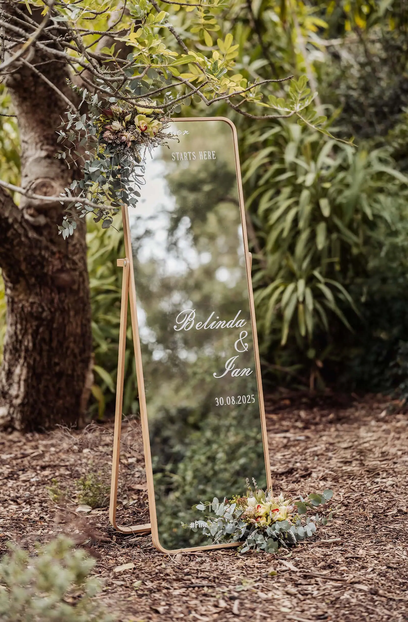 adelaide botanic gardens summerhouse wedding - belinda & ian 157 Outdoor wedding welcome sign with floral accents and elegant typography.