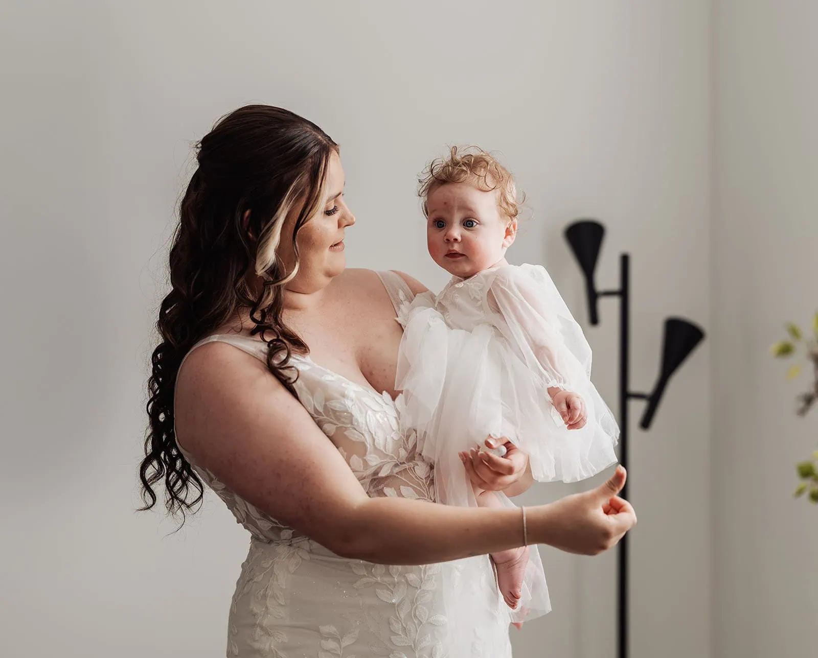 beach rd wines wedding - hana & jessie 42 Mother holding baby, sharing love and bonding moment.