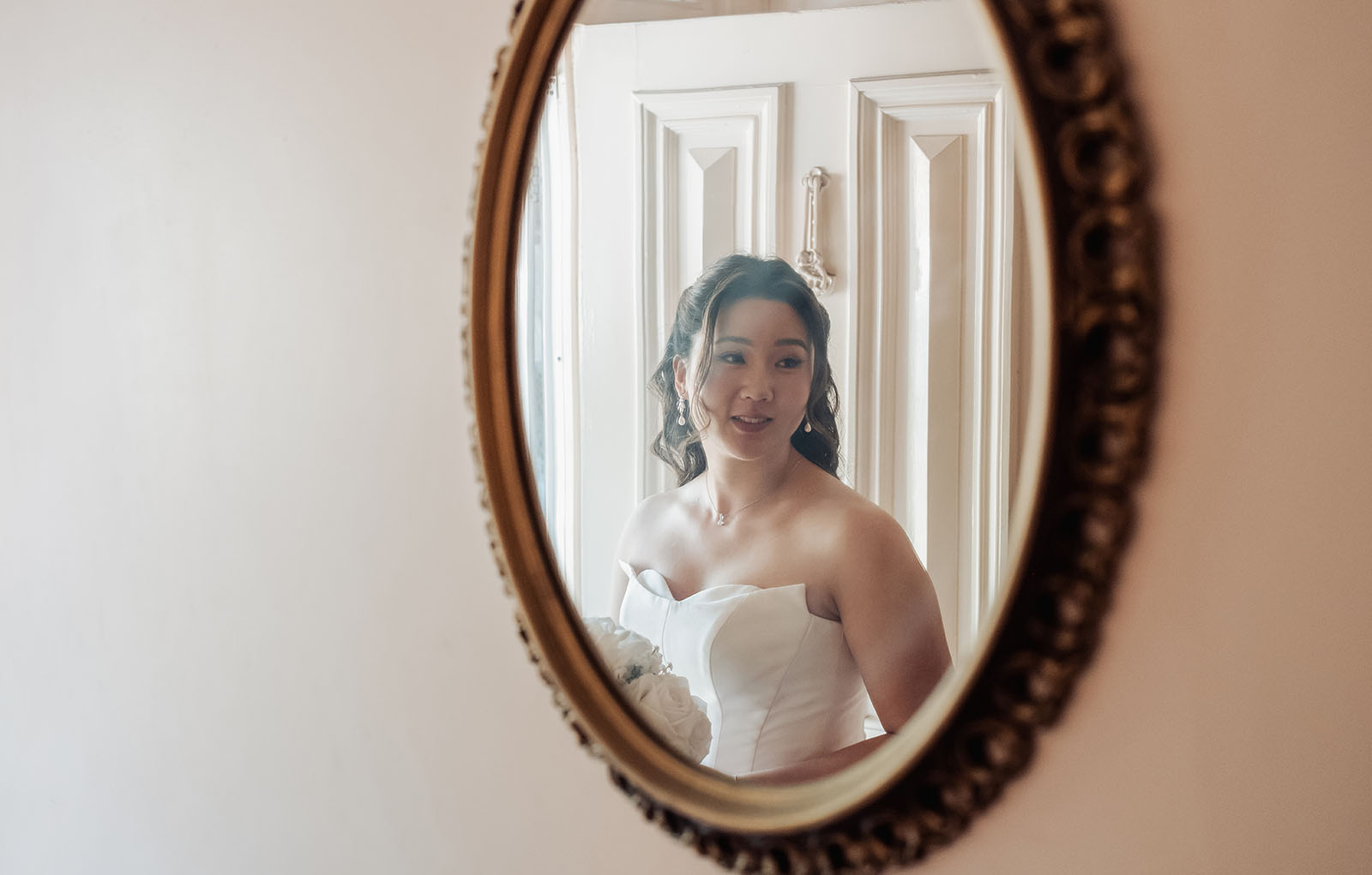 sunnybrae rose garden wedding - celina & anuj 13 Bride admiring herself in mirror, wedding dress reflection, bridal beauty captured.