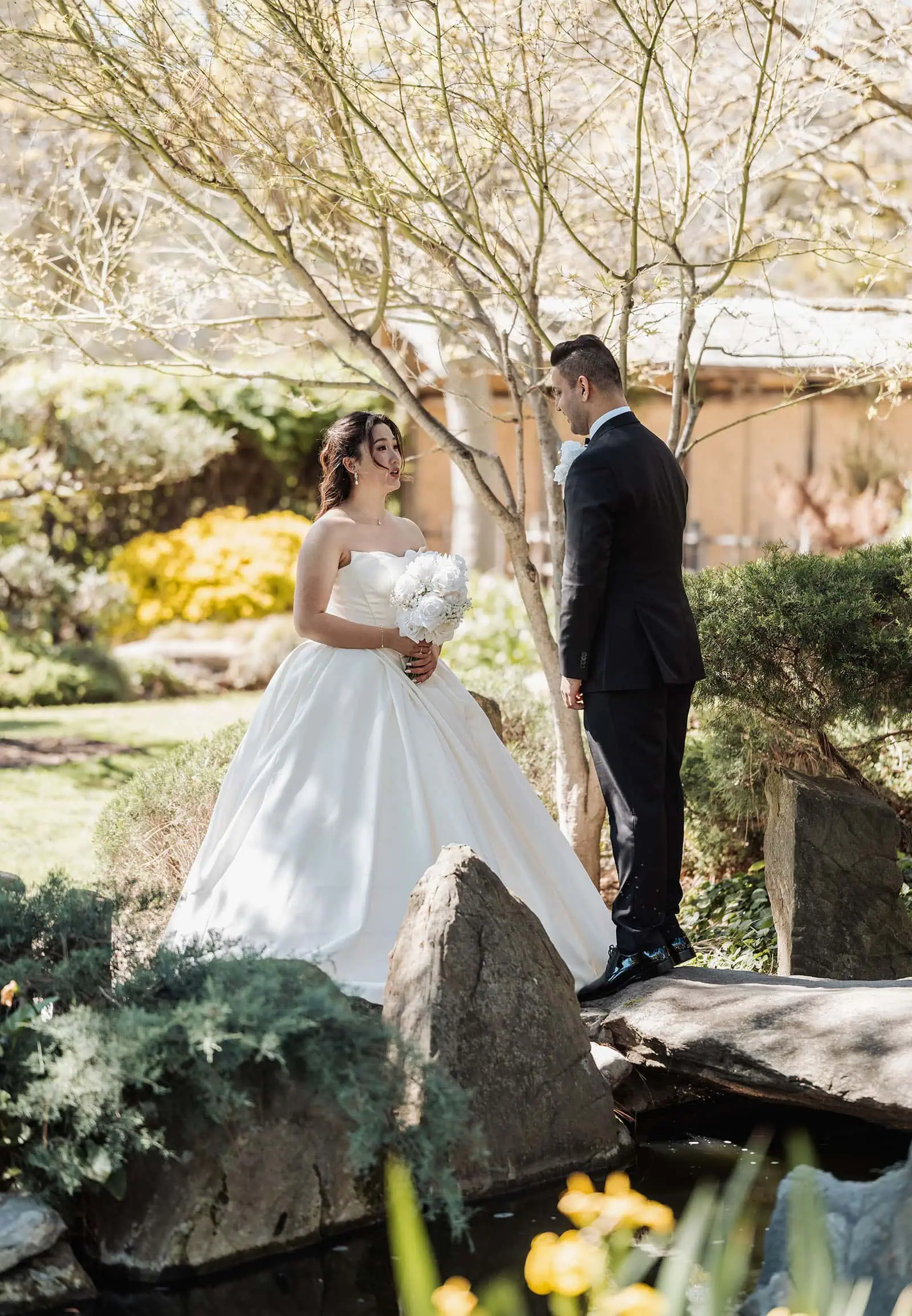 sunnybrae rose garden wedding - celina & anuj 19 Bride and groom embrace in a lush garden setting.