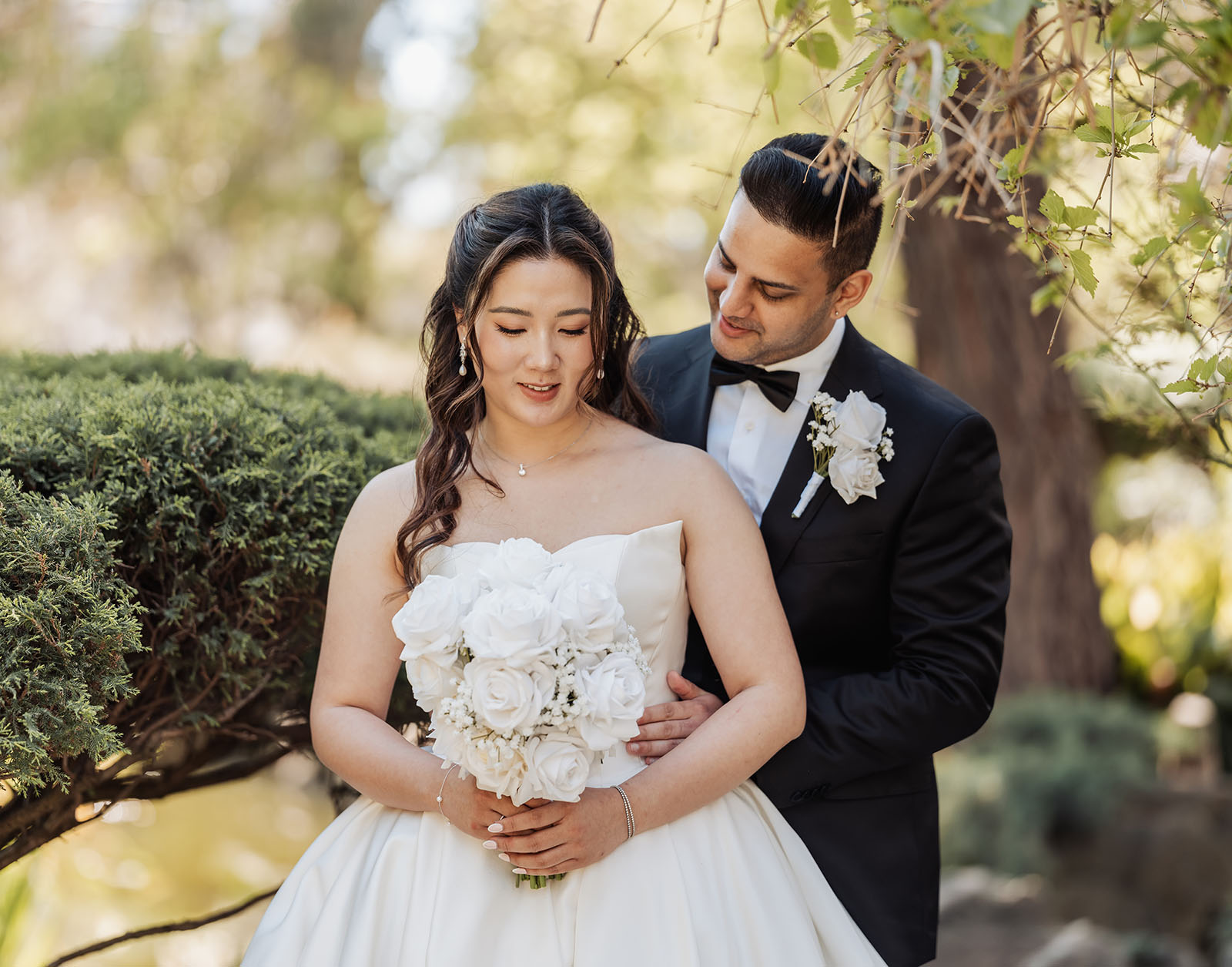 sunnybrae rose garden wedding - celina & anuj 27 Bride and groom share joyous outdoor wedding moment.