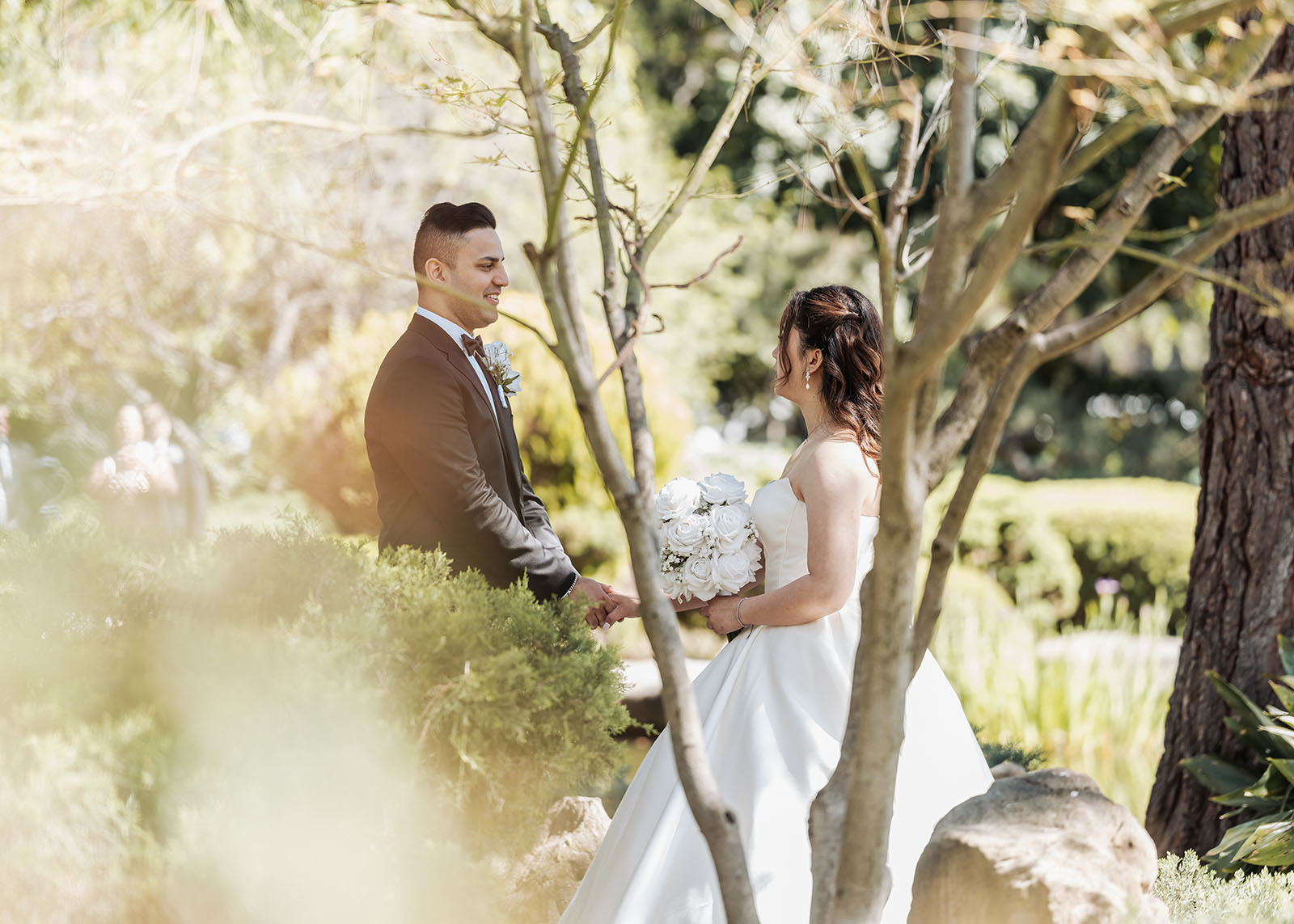 sunnybrae rose garden wedding - celina & anuj 21 Romantic couple enjoying a serene garden setting during sunset.