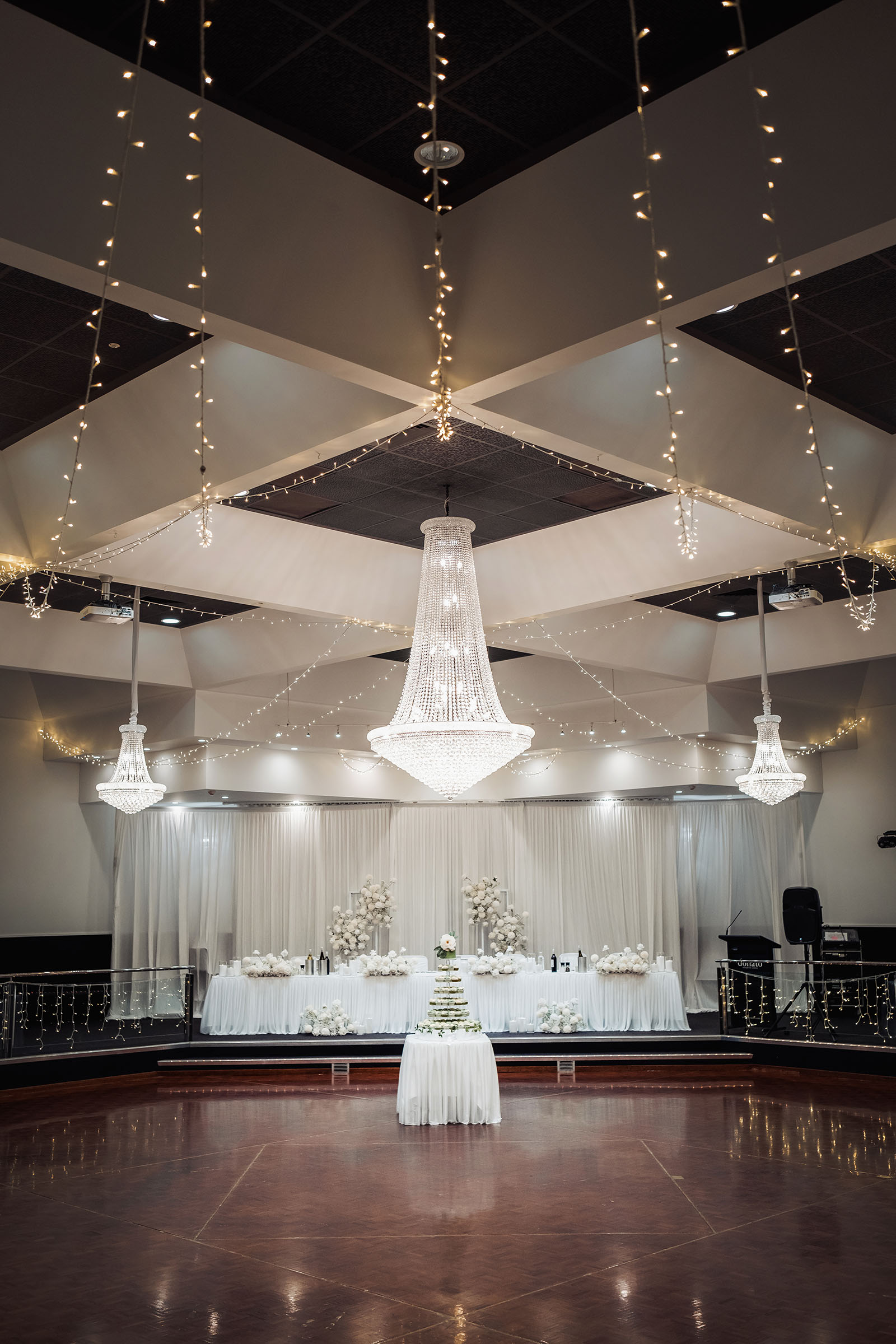 sunnybrae rose garden wedding - celina & anuj 68 Elegant event setup with exquisite tableware, floral decor, and ambient lighting.