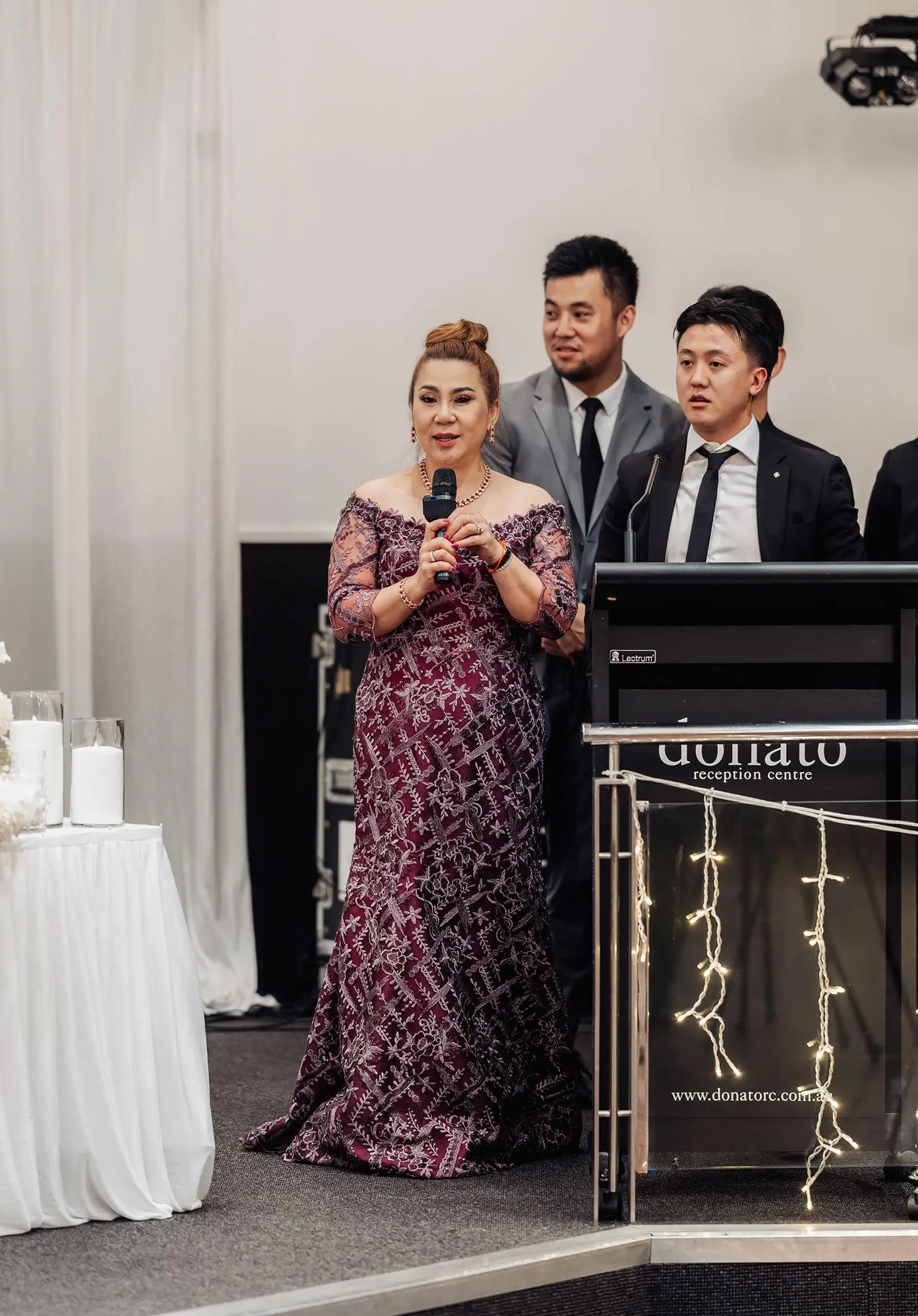 sunnybrae rose garden wedding - celina & anuj 79 Woman speaking at formal event in elegant gown.