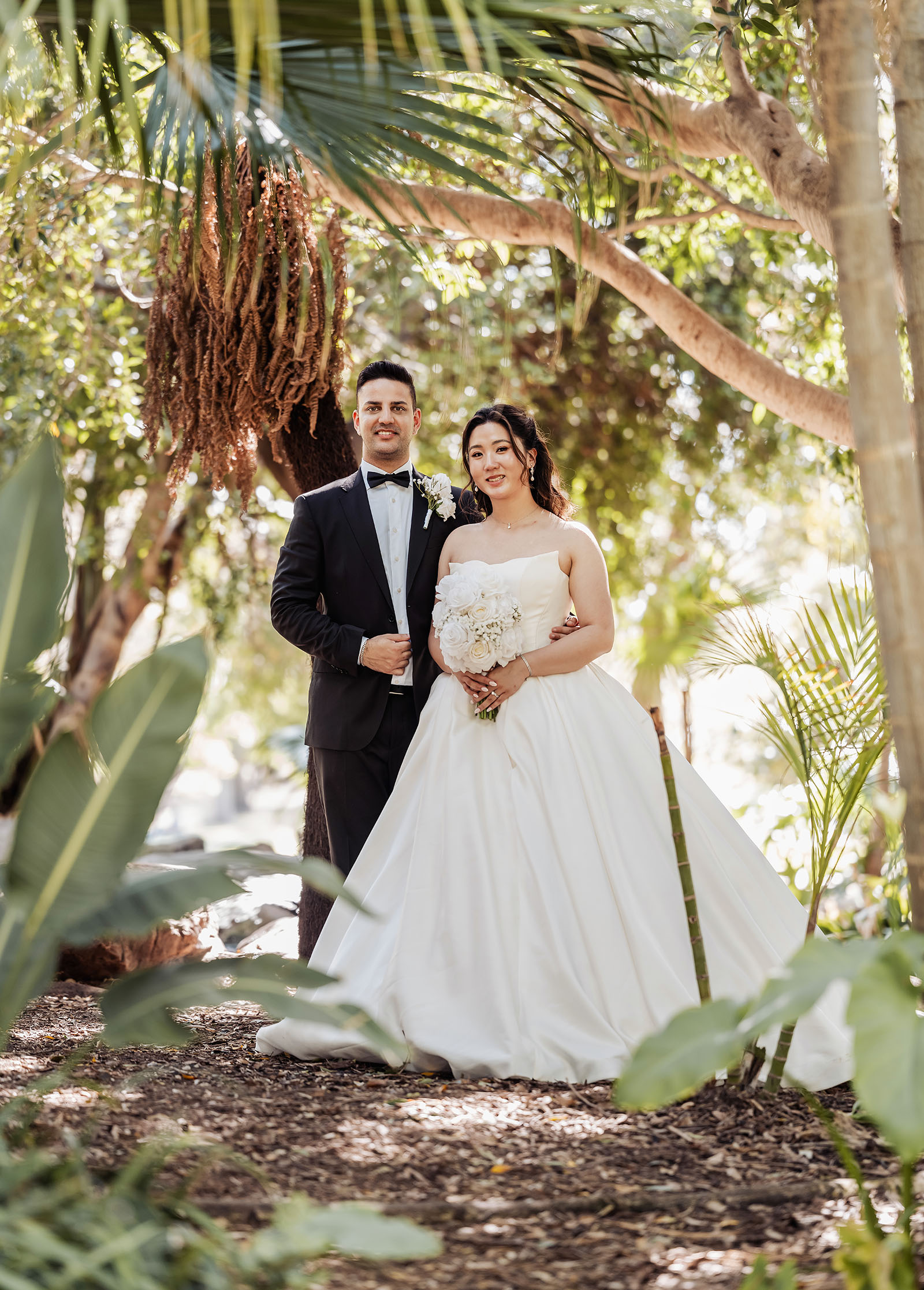 sunnybrae rose garden wedding - celina & anuj 62 Bride and groom embrace in picturesque garden, celebrating a romantic outdoor wedding.