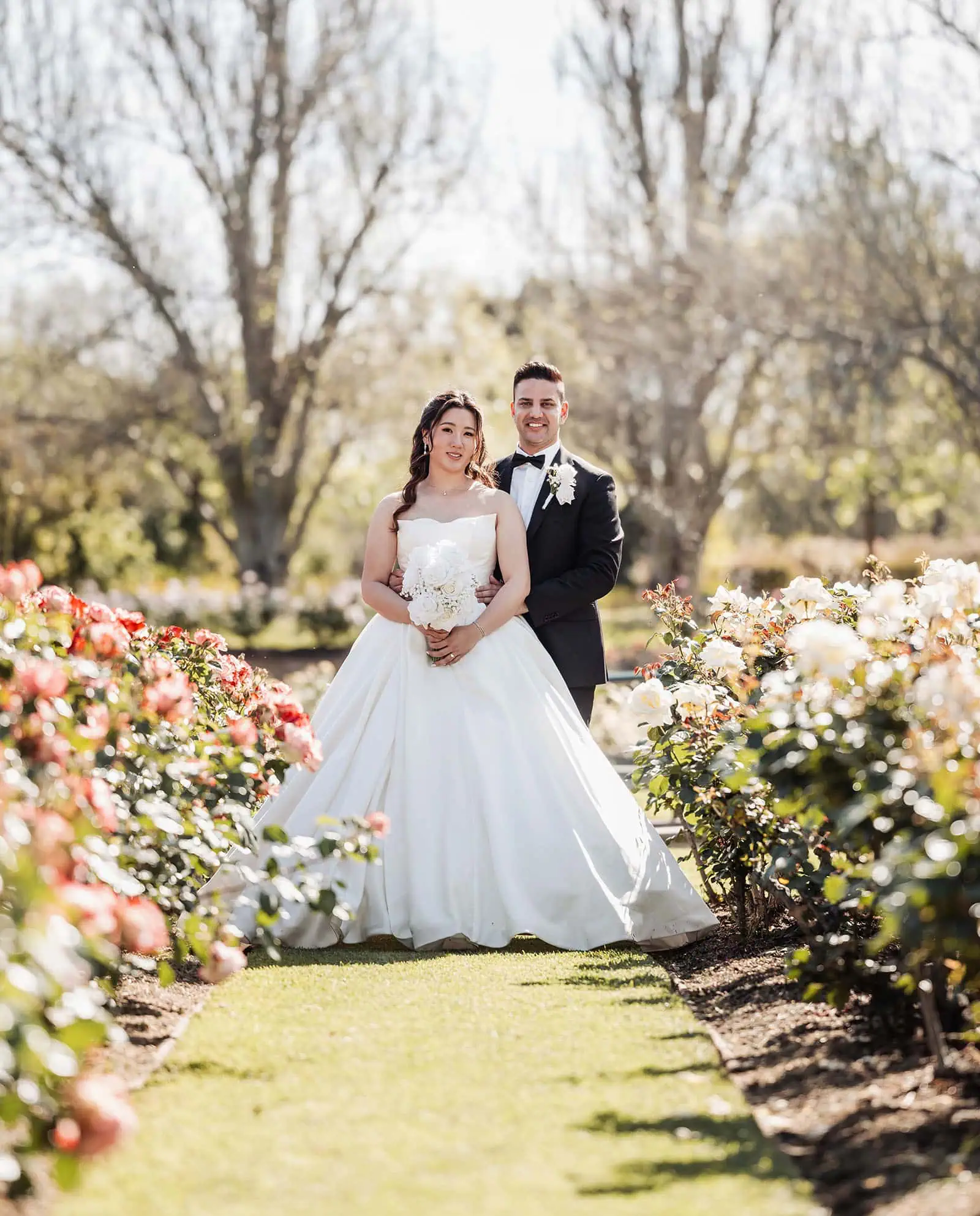 sunnybrae rose garden wedding - celina & anuj 61 Garden wedding venue with floral arch, elegant seating, and lush greenery.