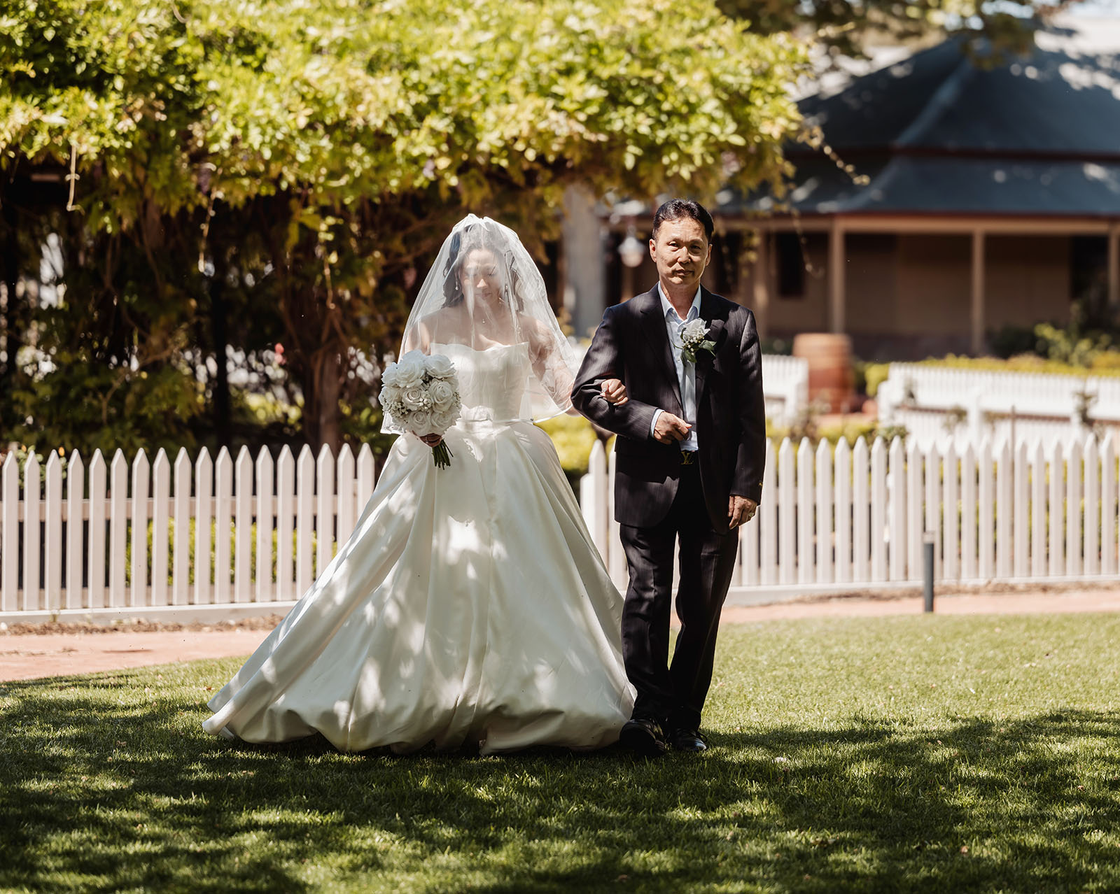 sunnybrae rose garden wedding - celina & anuj 42 Bride walking with father at outdoor wedding ceremony.