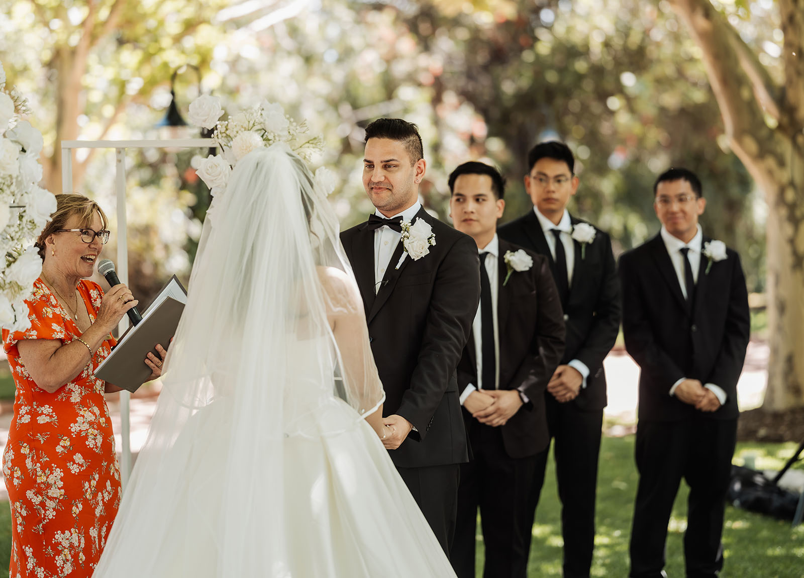 sunnybrae rose garden wedding - celina & anuj 45 Outdoor wedding ceremony with flowers, guests, and scenic views in a garden setting.