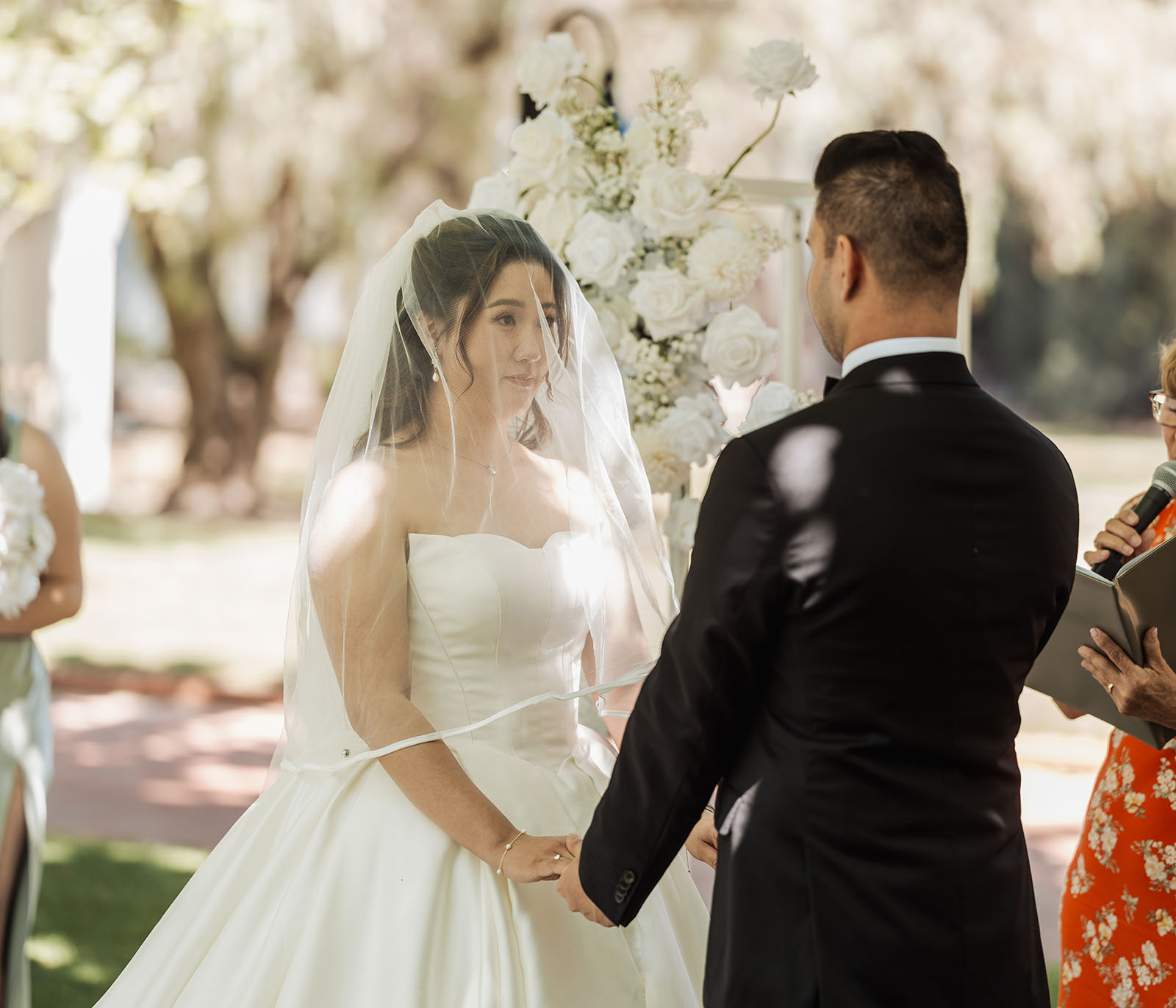 sunnybrae rose garden wedding - celina & anuj 46 Scenic outdoor wedding ceremony with elegant floral decorations and guests.