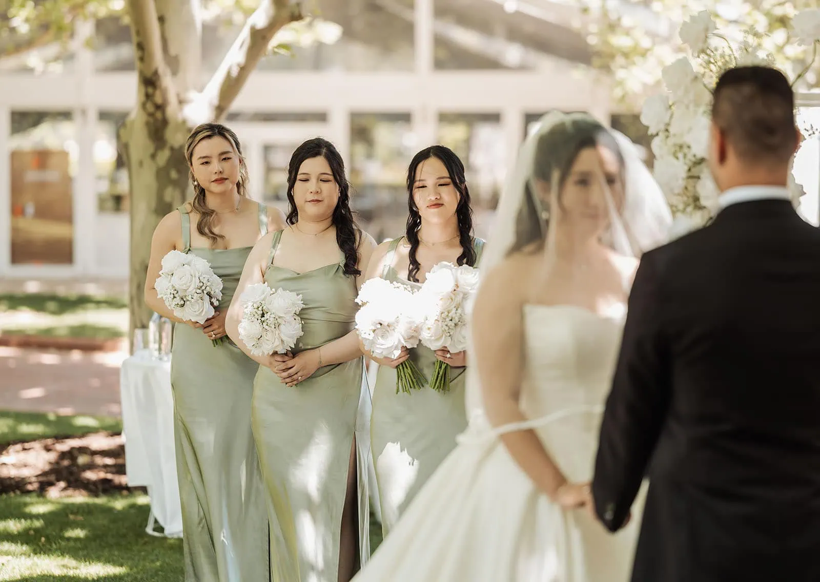 sunnybrae rose garden wedding - celina & anuj 47 Elegant outdoor wedding ceremony with flowers and guests gathered in a scenic garden.