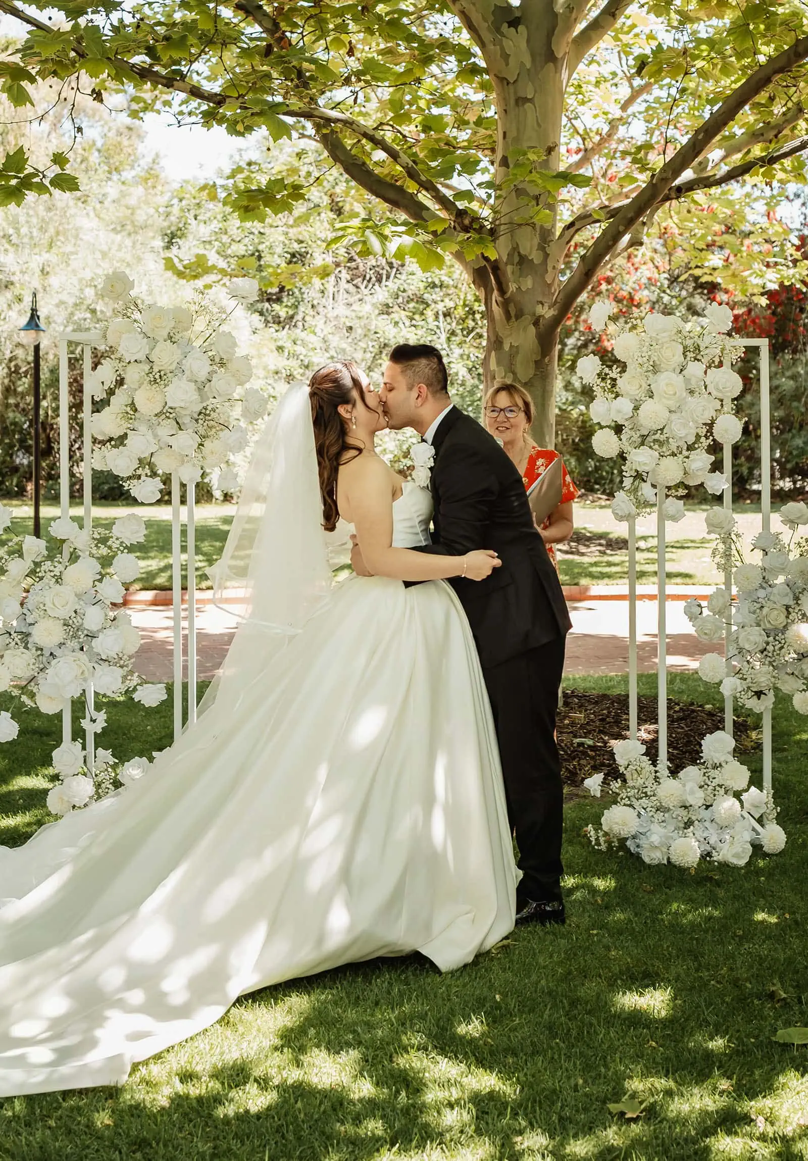 sunnybrae rose garden wedding - celina & anuj 49 Bride and groom kissing outdoors at romantic wedding ceremony.