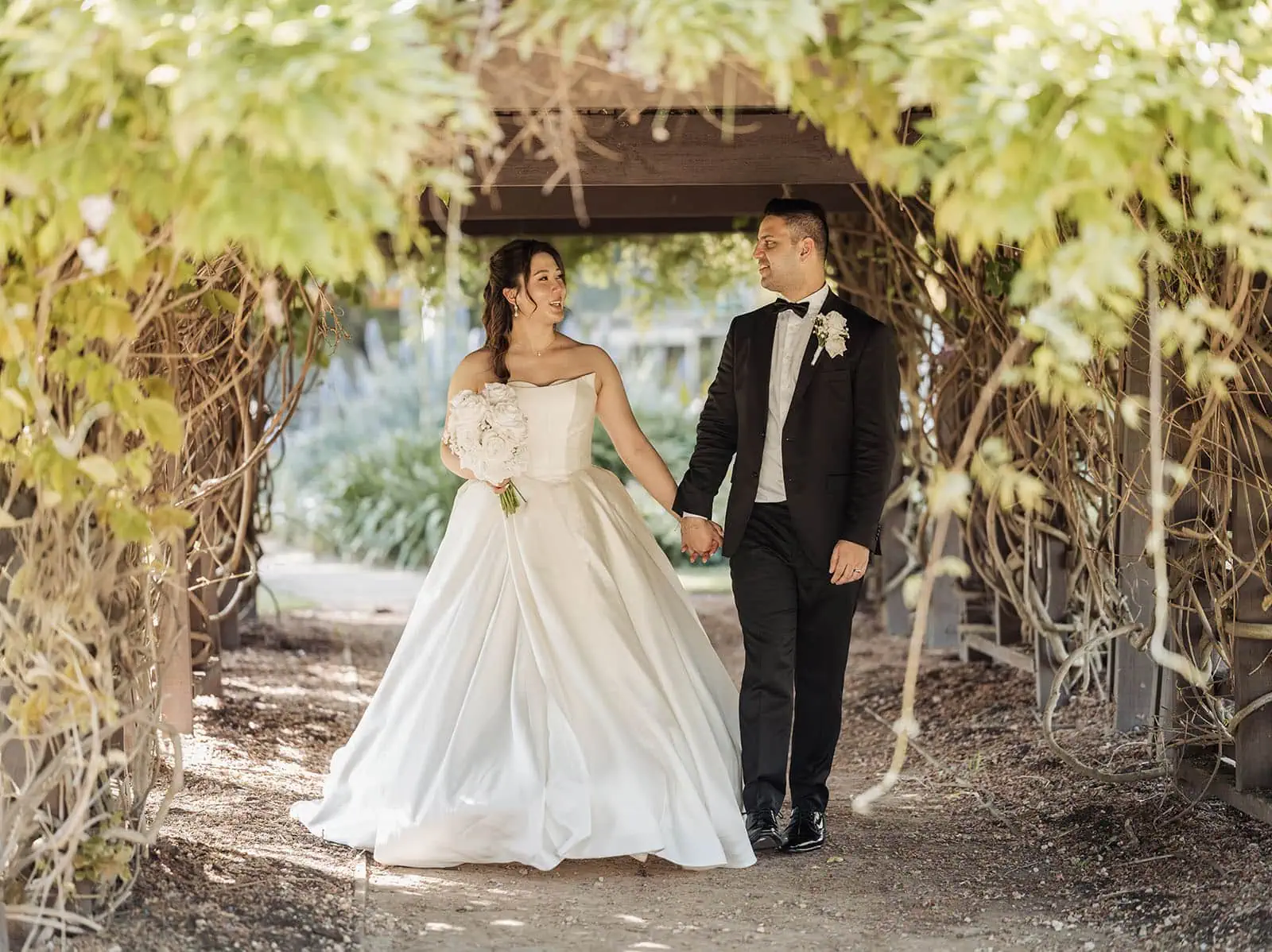 sunnybrae rose garden wedding - celina & anuj 64 Bride and groom share a moment under pergola on their wedding day.