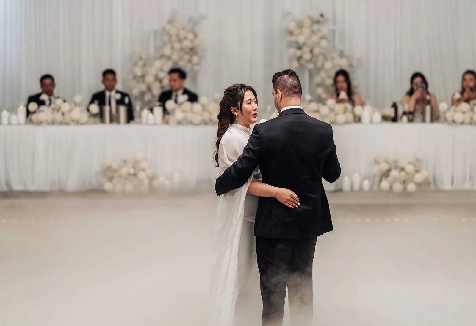 sunnybrae rose garden wedding - celina & anuj 86 Bride and groom share a romantic wedding dance under twinkling lights.
