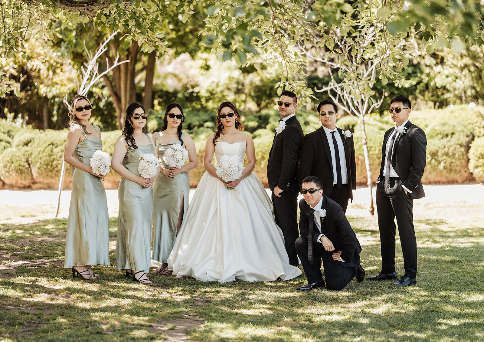 sunnybrae rose garden wedding - celina & anuj 38 Outdoor wedding party celebrating with friends under a sunny sky.