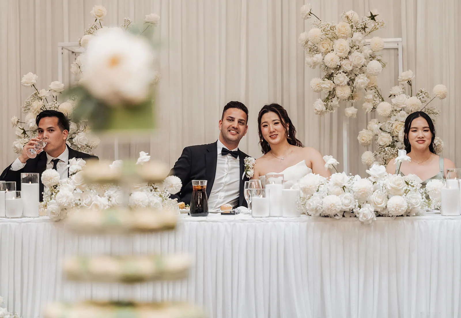 sunnybrae rose garden wedding - celina & anuj 76 Elegant wedding reception head table with floral arrangements and decorative settings.