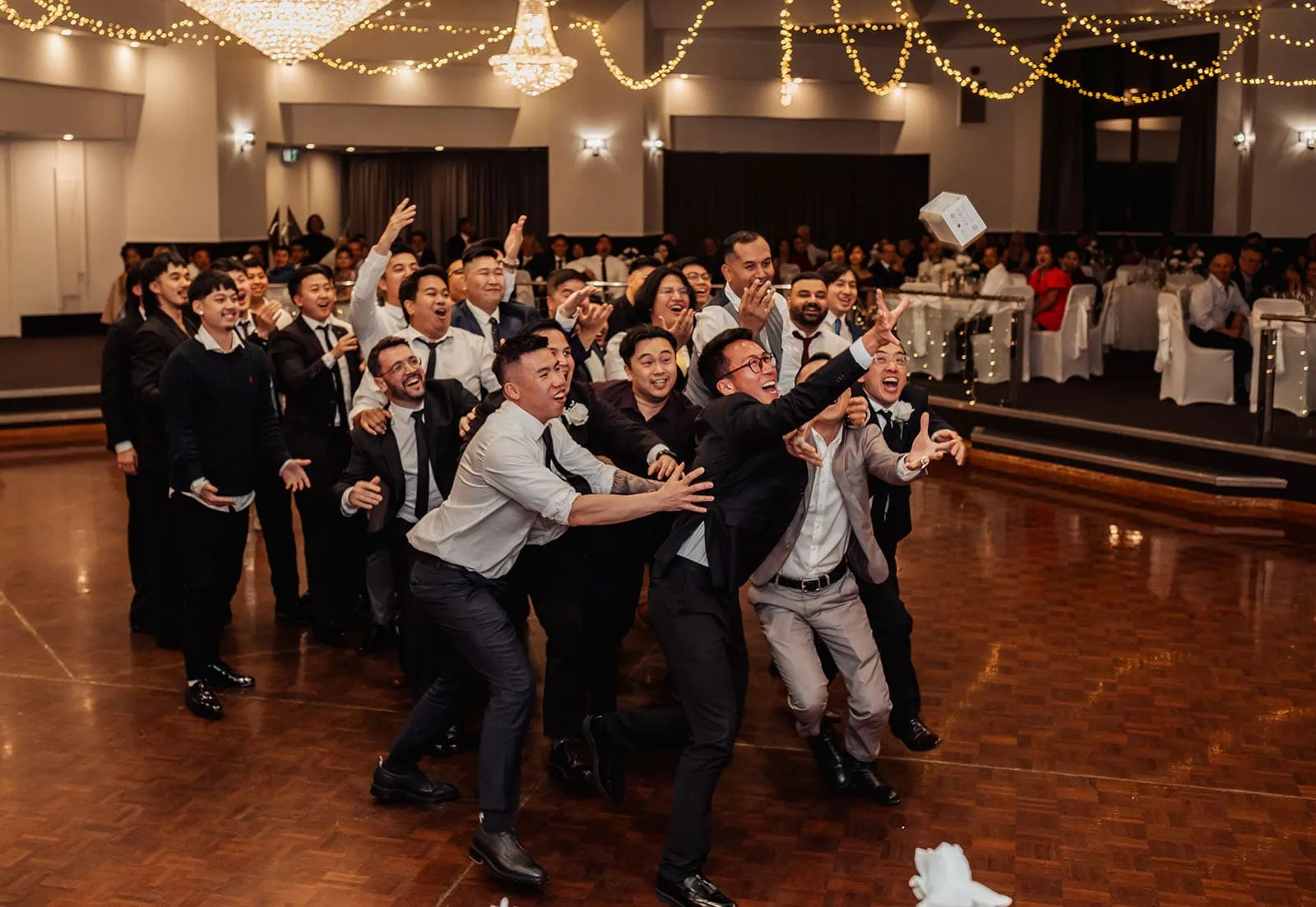 sunnybrae rose garden wedding - celina & anuj 81 Bride tossing bouquet at wedding reception, guests eagerly watching.