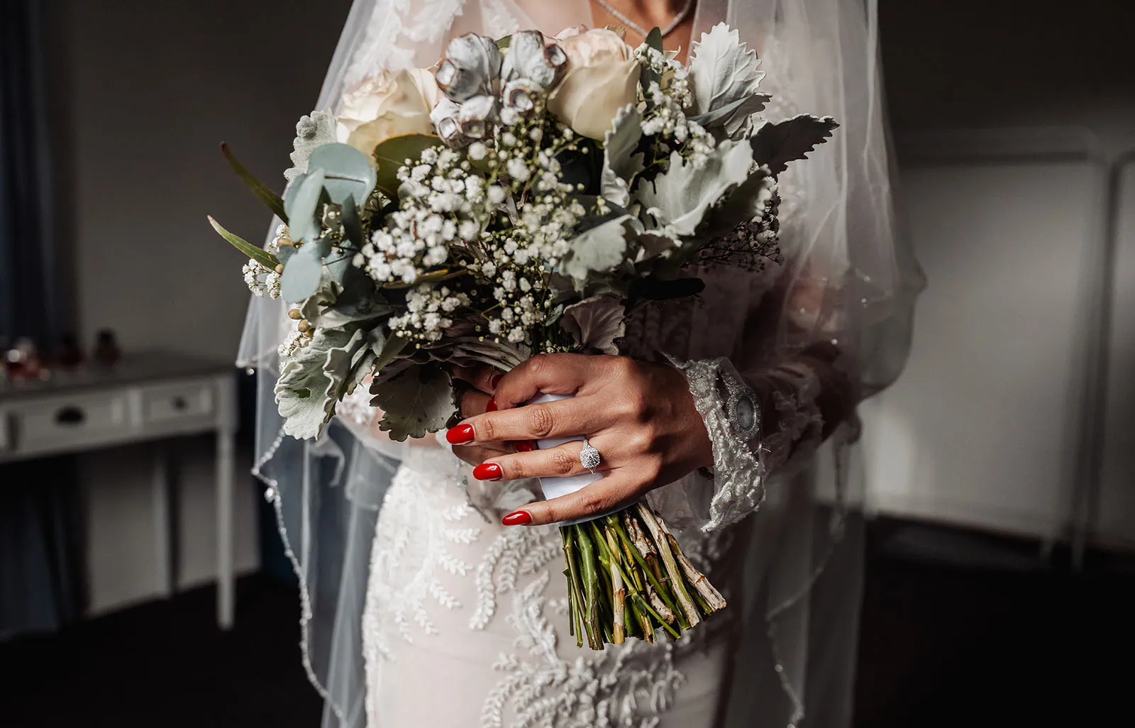 wedding at the manor in basket range - maryam & jason 125 Bride holding elegant floral bouquet at wedding ceremony.