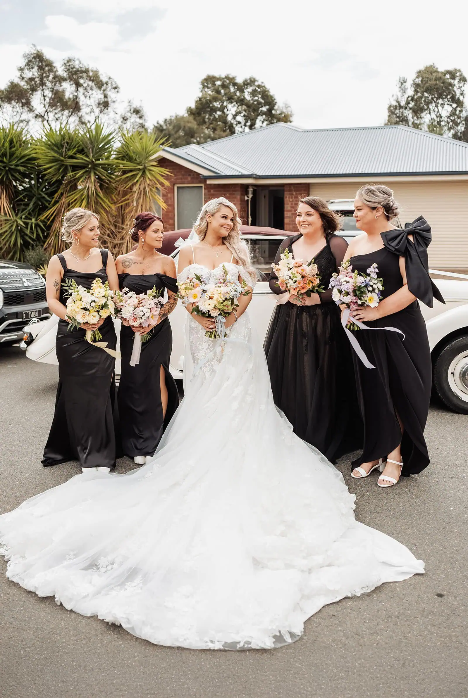 silvestris of clarendon wedding - sam & wayne 209 Bride and bridesmaids laughing together outdoors in sunshine.