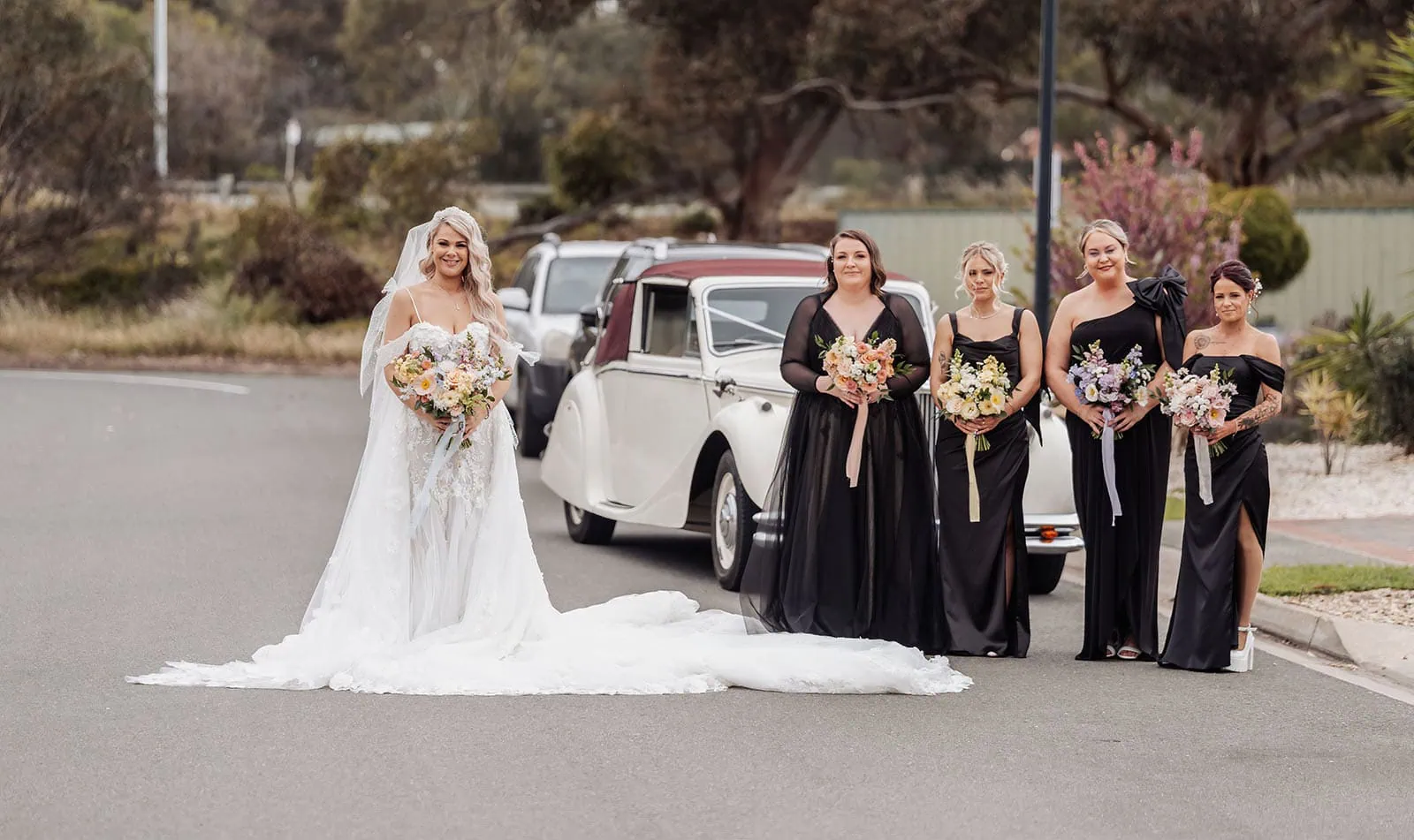 silvestris of clarendon wedding - sam & wayne 208 Bridal party posing with vintage car on wedding day.