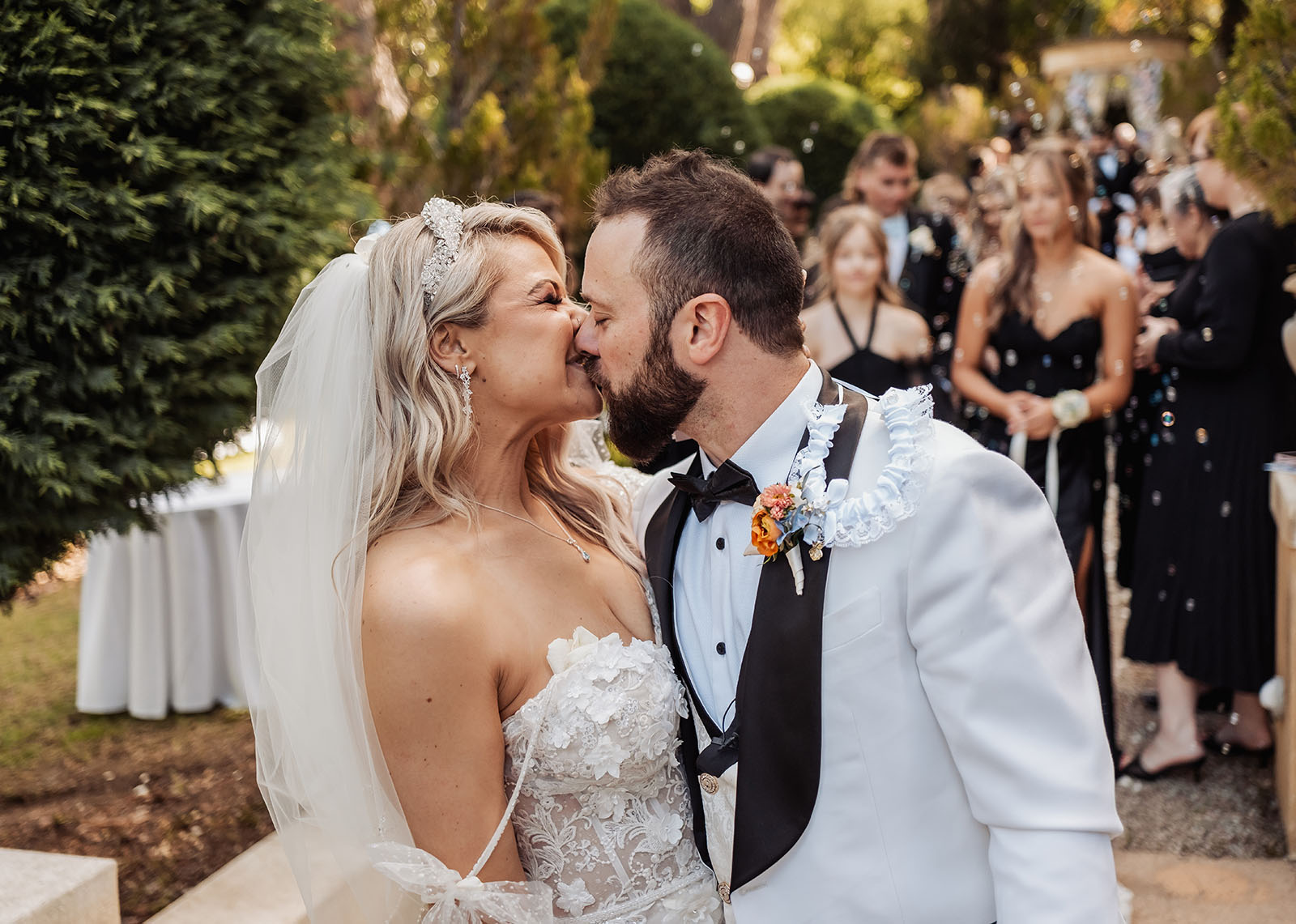 silvestris of clarendon wedding - sam & wayne 228 Bride and groom kissing during outdoor wedding ceremony.