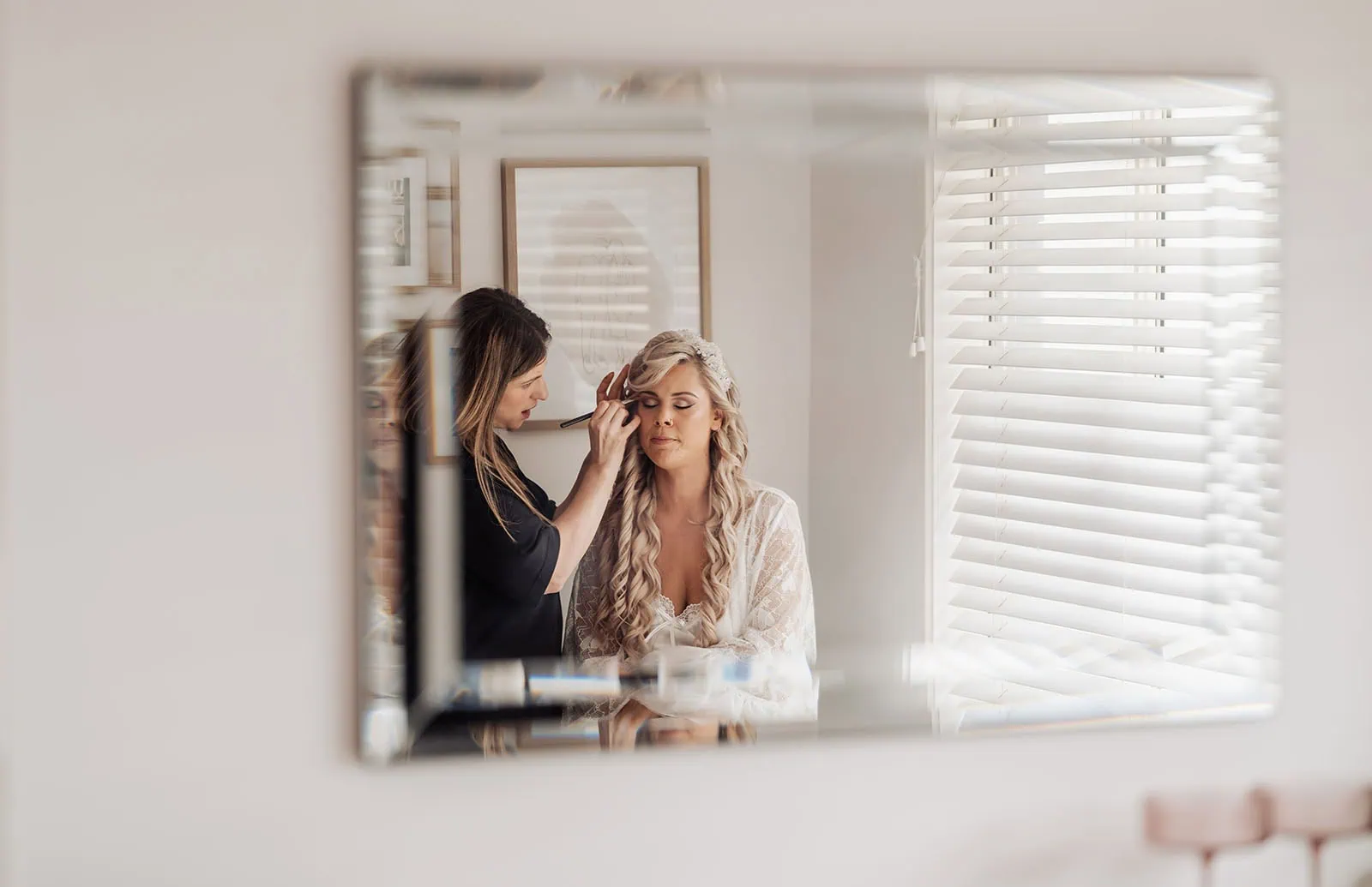 silvestris of clarendon wedding - sam & wayne 192 Bride applying makeup, reflected in mirror, preparing for wedding ceremony.